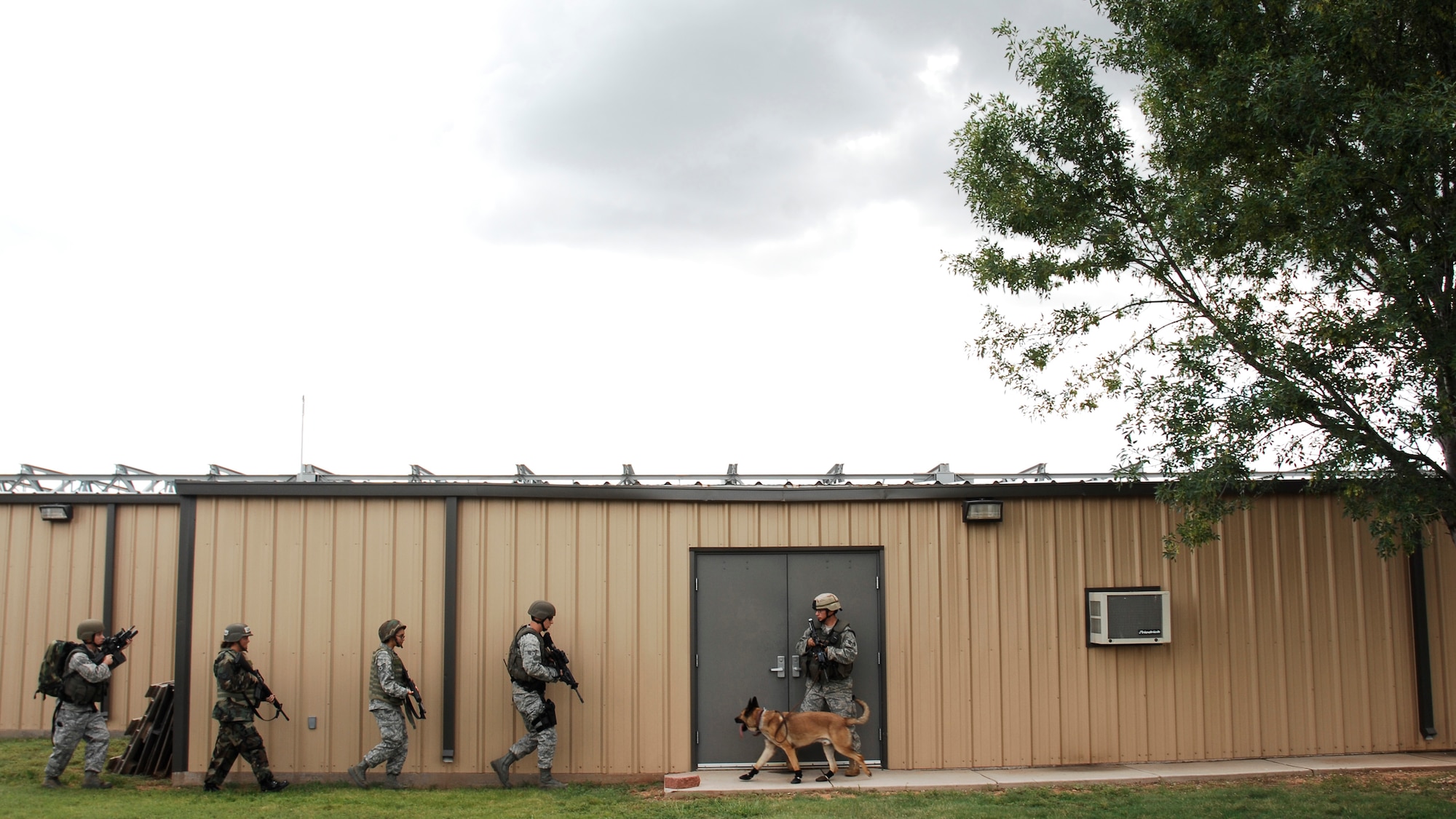 CANNON AIR FORCE BASE, N.M. -- Airmen from the 27th Special Operations Security Forces Squadron move in to secure a building during an exercise Aug. 27.  The exercise was an evaluation of Cannon's response to a domestic terrorism event. It determined shortfalls, limitations and training opportunities to enhance effectiveness during increased Force Protection Condition measures. (U.S. Air Force photo/Senior Airman Liliana Moreno) 