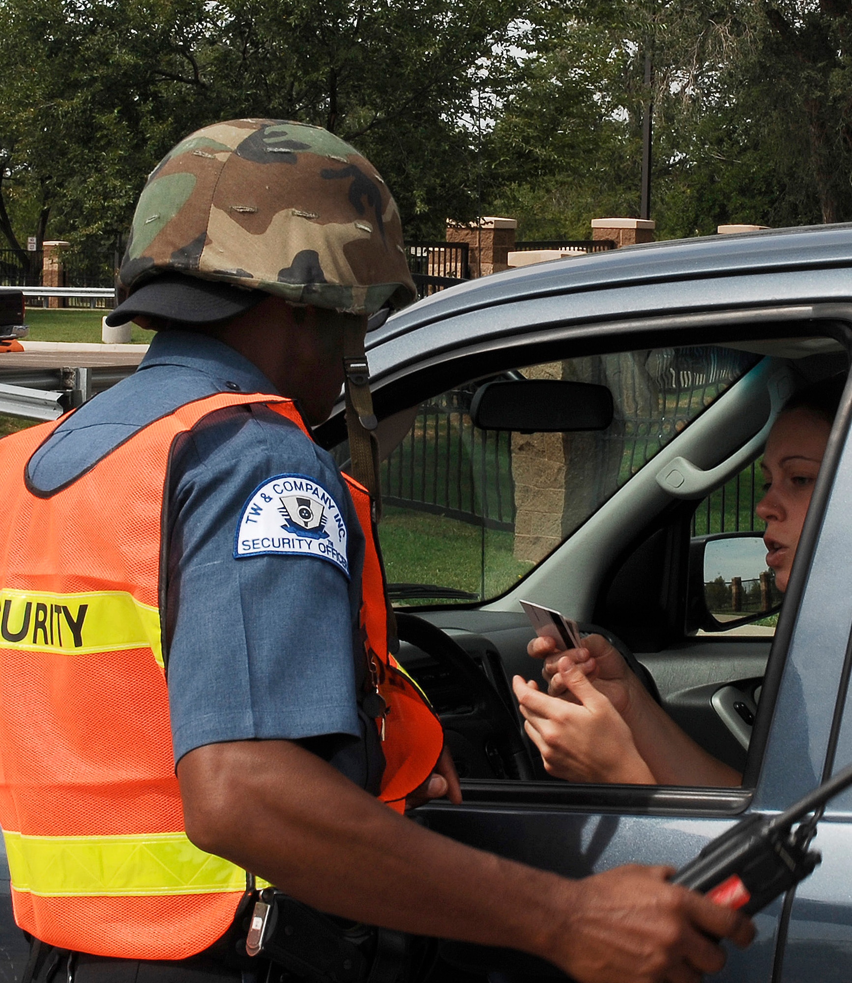 CANNON AIR FORCE BASE, N.M. -- Security officer Ted Sharpe, checks an identification card at the base's front gate during a training exercise Aug. 27.  The base exercised the full barrier plan and implemented force protection condition measures. (U.S. Air Force photo/Senior Airman Liliana Moreno) 