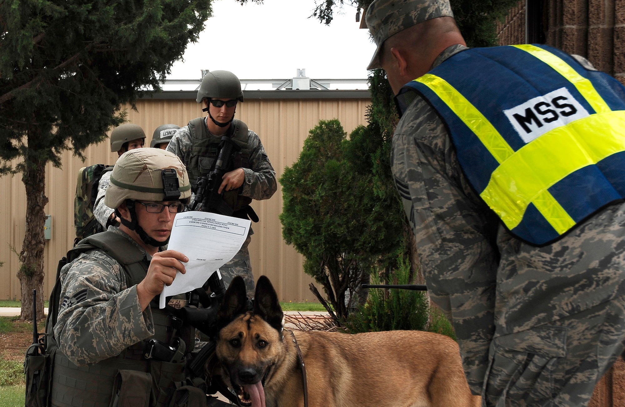 CANNON AIR FORCE BASE, N.M. -- Senior Airman Justin Carpenter, 27th Special Operations Security Forces Squadron, reads instructions prior to leading his team during an exercise Aug. 27. The exercise was a evaluation of Cannon's response to a domestic terrorism event.  It determined shortfalls, limitations and training opportunities to enhance effectiveness during increased Force Protection Condition measures.  (U.S. Air Force photo/Senior Airman Liliana Moreno) 