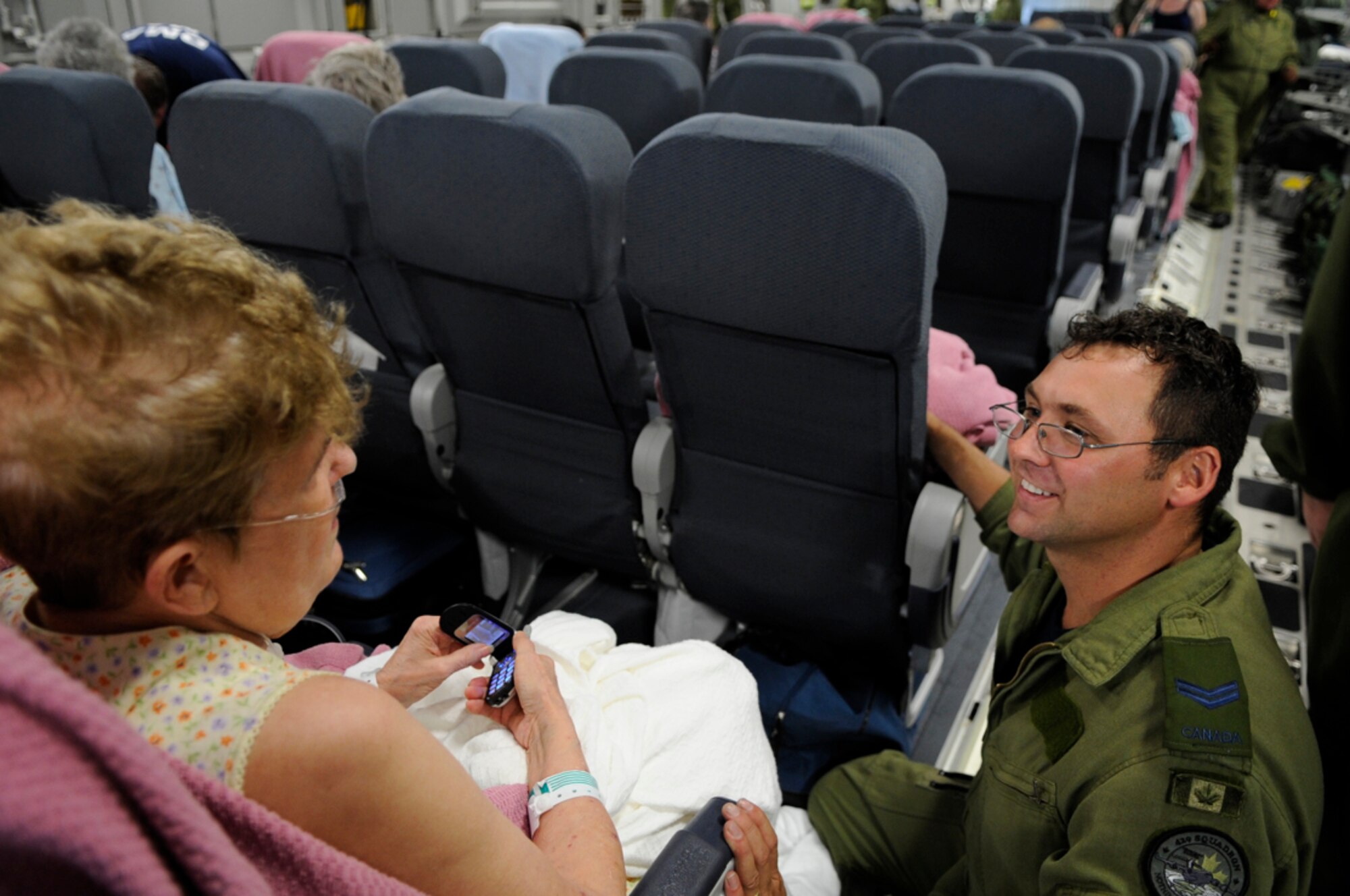 Canadian Air Force Cpl. Patrick Richer helps an evacuee of Hurricane Gustav board a flight the U.S. Federal Emergency Management Agency and The Department of Defense has chartered to transport citizens to destinations safely outside the hurricanes path at Lake Front Airport, New Orleans, LA., Aug. 31, 2008. (U.S. Air Force photo by Staff Sgt. Shawn Weismiller)