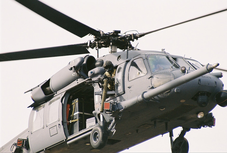 A flight engineer from the 305th Rescue Squadron mans a GAU-2/C Minigun mounted to the outside of the HH-60 Pave Hawk helicopter while scanning for targets during a local training exercise.  A typical crew of an HH-60 helicopter consists of a pilot, co-pilot, flight engineer, gunner and 2-3 pararescuemen. (Courtesy photo)
