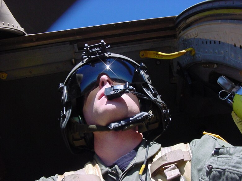 A 305th Rescue Squadron flight engineer scrans the terrain for harzards during a low-level flight. (Courtesy photo)