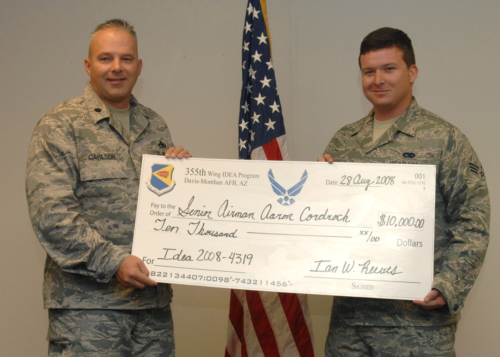 Lt. Col. David Carlson, 755th Aircraft Maintenance Squadron commander, presents Senior Airman Aaron Cordroch, 755th Aircraft Maintenance Squadron, a check for $10,000 from the IDEA Program here Aug. 28. After installing six exterior infrared sensors on the EC-130H over a course of a year, Airman Cordroch noticed a trend.  Moisture was entering the sensor and significant corrosion was causing system failure.  Airman Cordroch’s idea to implement the use of a special seal to protect the delicate instruments will save approximately $38,000.  Estimated savings for the first year will be over $222,000.  The IDEA Program stands for Innovative Development through Employee Awareness.  This program is the Air Force’s way of soliciting suggestions to save time, money and lives.  The program is open to all Air Force Active Duty and civilian employees.  (U.S. Air Force photo by Senior Airman Jacqueline Romero) 