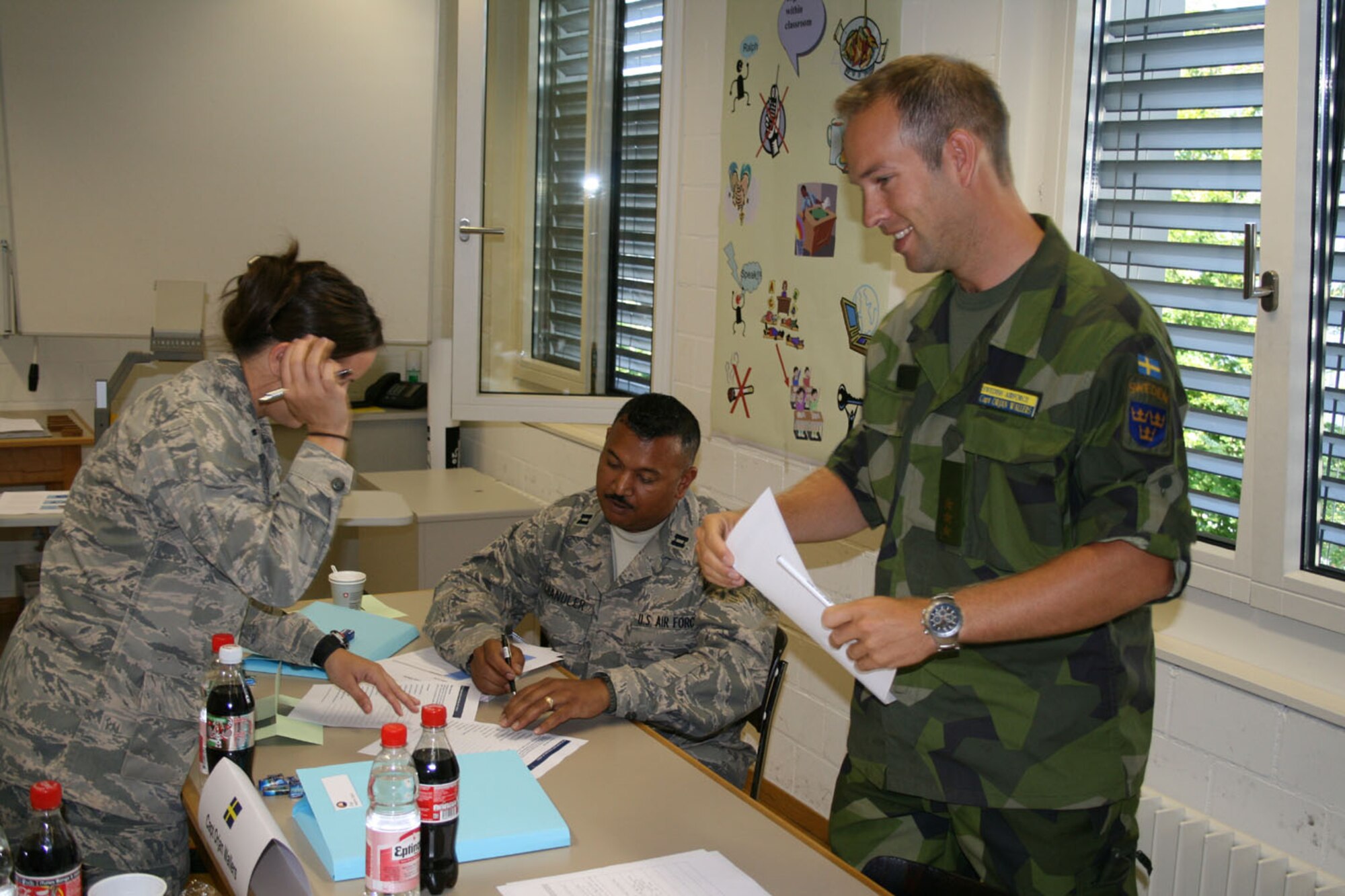 SEYMOUR JOHNSON AIR FORCE BASE, N.C. -- Capt. Neil Chandler (sitting), a Reservist with the 916th Logistics Readiness Squadron, participates in some classroom discussion while attending the International Junior Officers Leadership Development Seminar in Switzerland. Capt. Chandler was one of 68 officers chosen for the opportunity from the U.S., Sweden, Italy, Canada, Switzerland, the U.K., Germany and the Netherlands. The course lasts one week and focuses on various leadership topics within an international military community. Capt. Chandler returned from a six-month deployment to Afghanistan earlier this year where he was recognized for his outstanding leadership abilities as company grade officer of the quarter while stationed there.