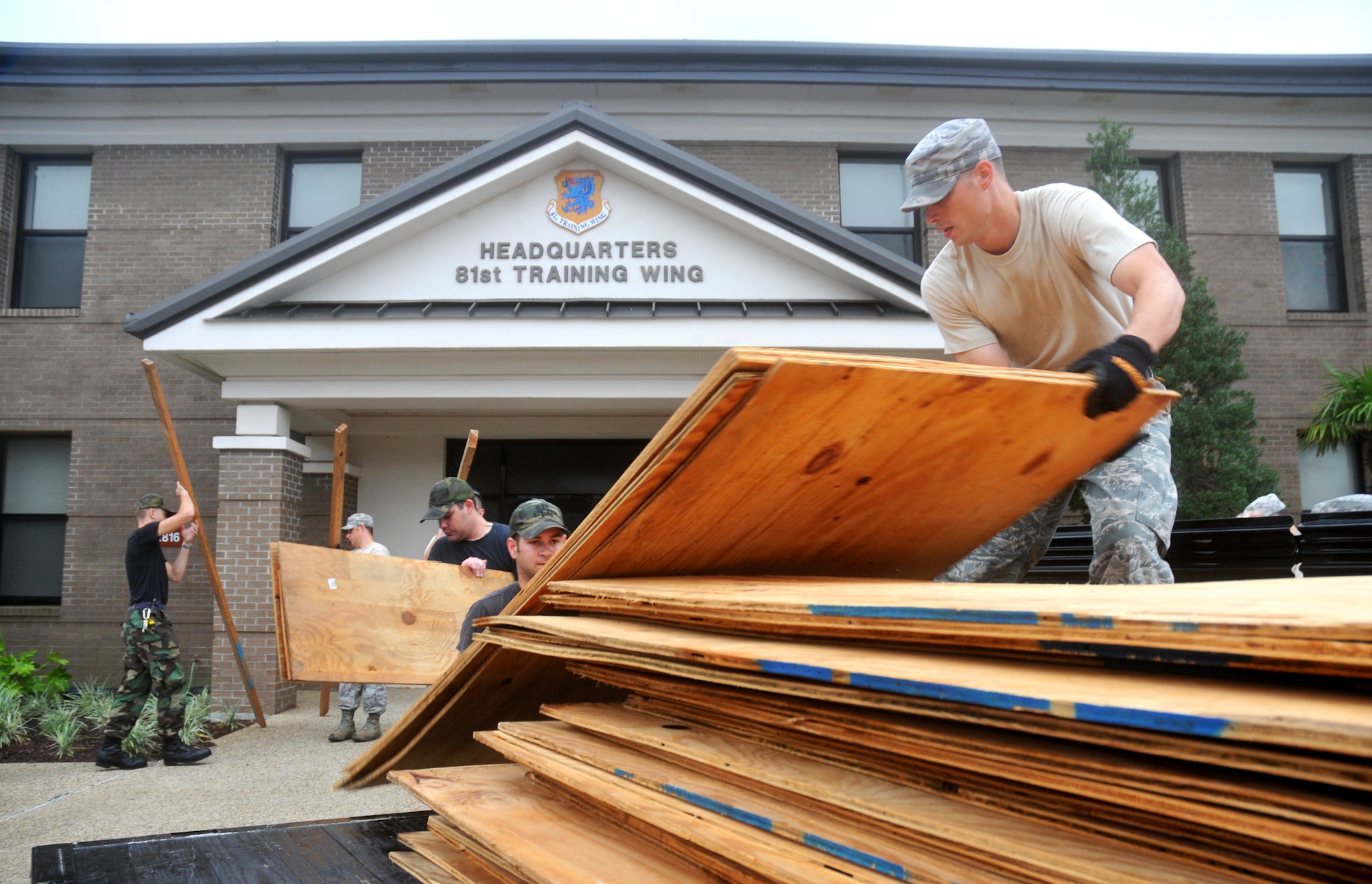 Members of the 81st Civil Engineer Squadron remove plywood installed for Hurricane Gustav from the windows of the 81st Training Wing headquarters building.  Hardening removal procedures began in the morning, 2 September, 2008 (U.S. Air Force photo by Adam Bond).