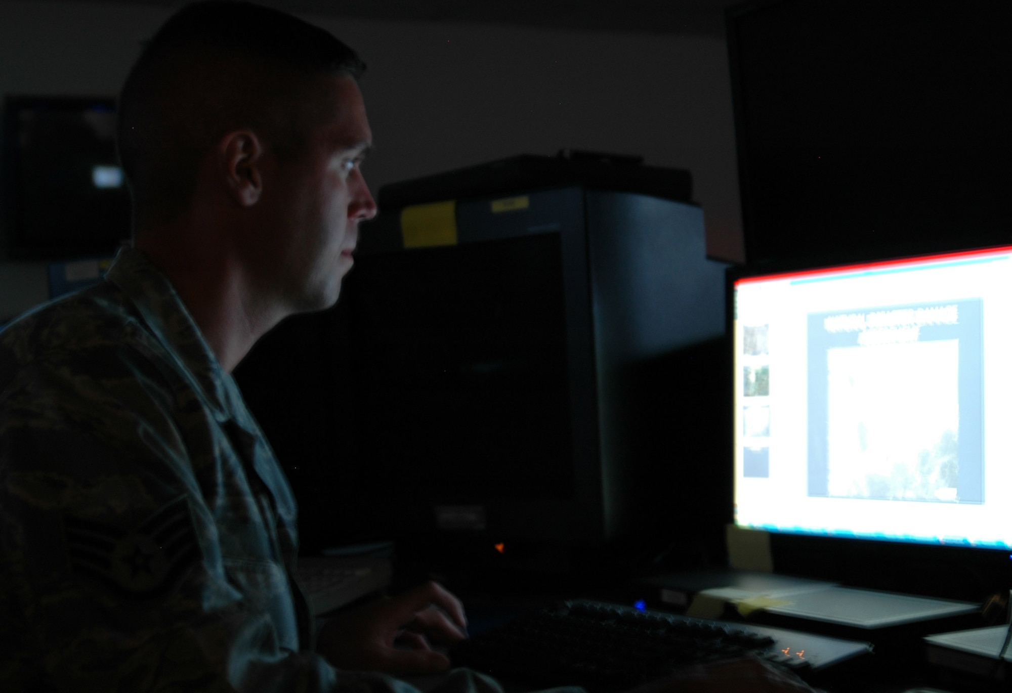 Staff Sgt. Joshua Orr, an imagery analyst with the 30th Intelligence Squadron at Langley Air Force Base, Va., reviews previous damage assessments from Hurricane Katrina between contingency taskings from Central Command. Officials at the 9th Reconnaissance Wing at Beale AFB, Calif., are shifting their CENTCOM taskings to the 30th IS so they can assist with Hurricane Gustav. (U.S. Air Force photo/Master Sgt. Steve Goetsch)
