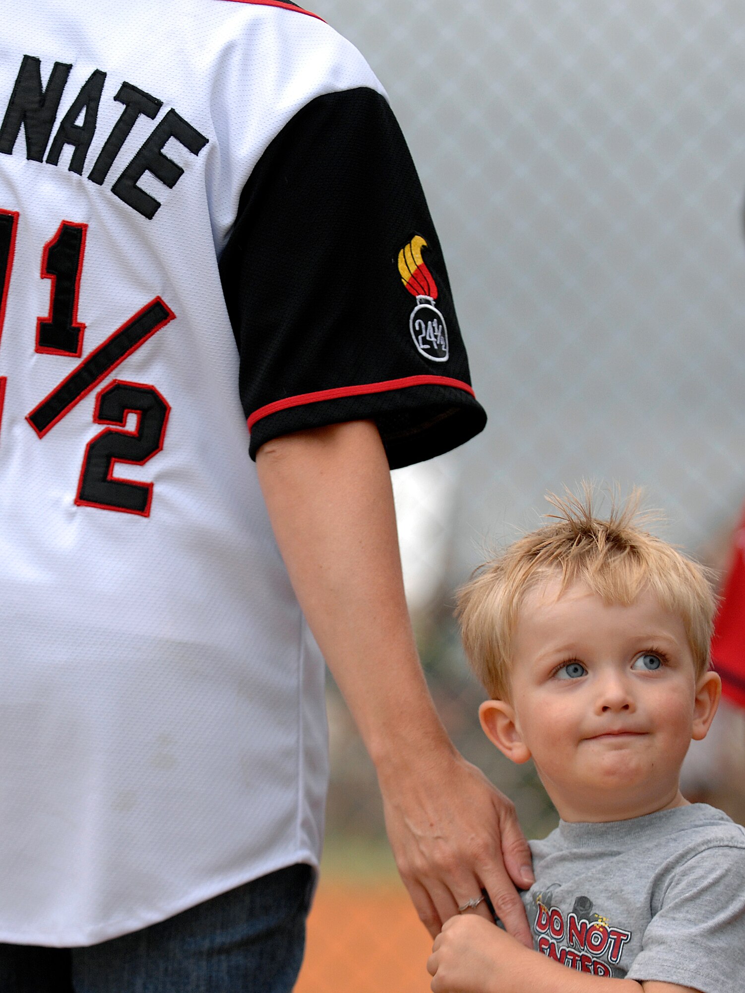 LANGLEY AIR FORCE BASE, Va. -- Julie Clark, wife of Tech. Sgt. Nathaniel Clark, 1st Equipment Maintenance Squadron, reaches for their son Tyler during the softball championship game against the 1st Communications Squadron Aug. 28.  The 1st CS handed 1st EMS its first loss of the year, 18-15, in the finale. (U.S. Air Force photo/Senior Airman Vernon Young)