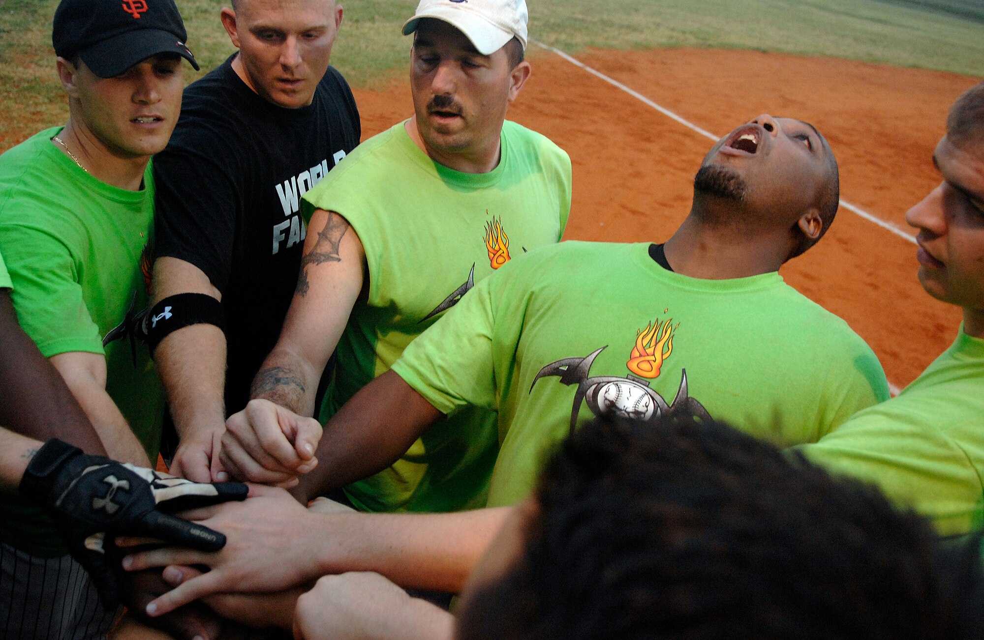 LANGLEY AIR FORCE BASE, Va. -- Staff Sgt. Tracy Ebron, 1st Equipment Maintenance Squadron, leans back to lead his team in a chant before playing in the base softball championship game against the 1st Communications Squadron Aug. 28.  The 1st CS handed 1st EMS its first loss of the year, 18-15, in the finale.  (U.S. Air Force photo/Senior Airman Vernon Young)