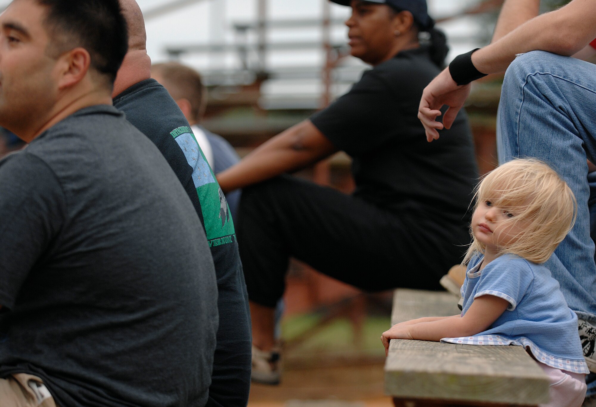 LANGLEY AIR FORCE BASE, Va. -- Destiny James, granddaughter of Tech. Sgt. Allen Warden, 1st Equipment Maintenance Squadron, watches the softball championship game from the bleachers with other EMS fans, Aug. 28.  The 1st EMS finished the season unbeaten, but lost the championship game to the 1st Communications Squadron 18-15.  (U.S. Air Force photo/Senior Airman Vernon Young)
