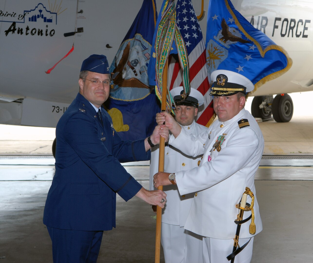 Col. Ronald Buckley (left), 12th Operations Group commander, assumes command of the 562nd Flying Training Squadron from Navy Cmdr. John Radka during a change of command ceremony Aug. 29. Commander Radka is the last U.S. Navy officer to command the 562nd. (U.S. Air Force photo by Don Lindsey)
