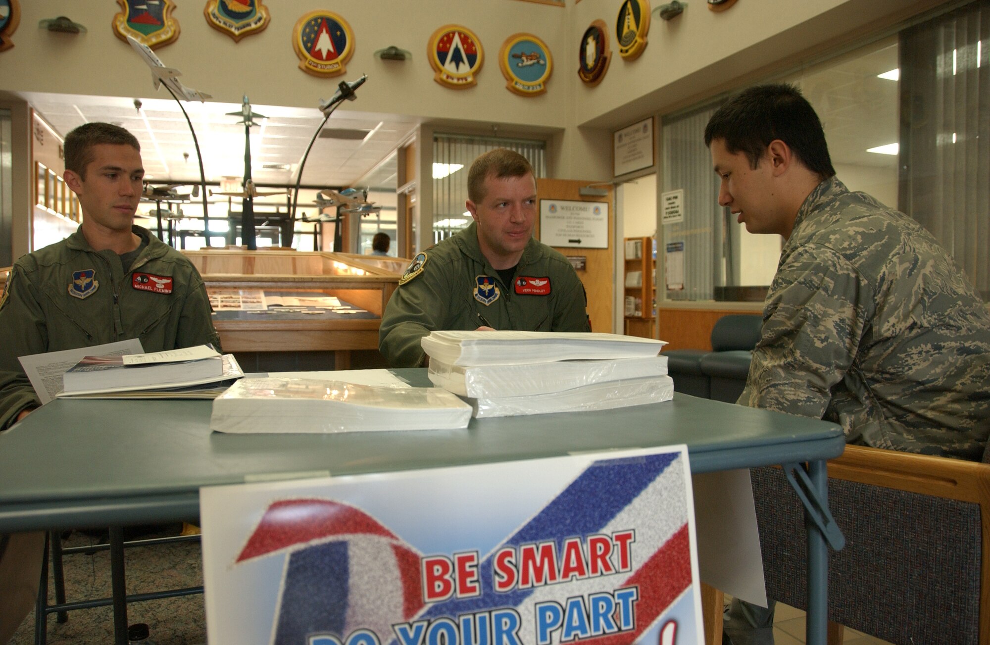 Maj. Vern Pendley (center), installation voting assistance officer, talks with 2nd Lt. John Hatfield, student pilot, about registering to vote and receiving an absentee ballot Sept. 2 at Bldg. 500. Voting assistance is available in Bldg. 500 this week 8 a.m. to noon, and 9 a.m. to 7 p.m. Saturday at the base exchange. (U.S. Air Force photo by Staff Sgt. Brian Hill)                               