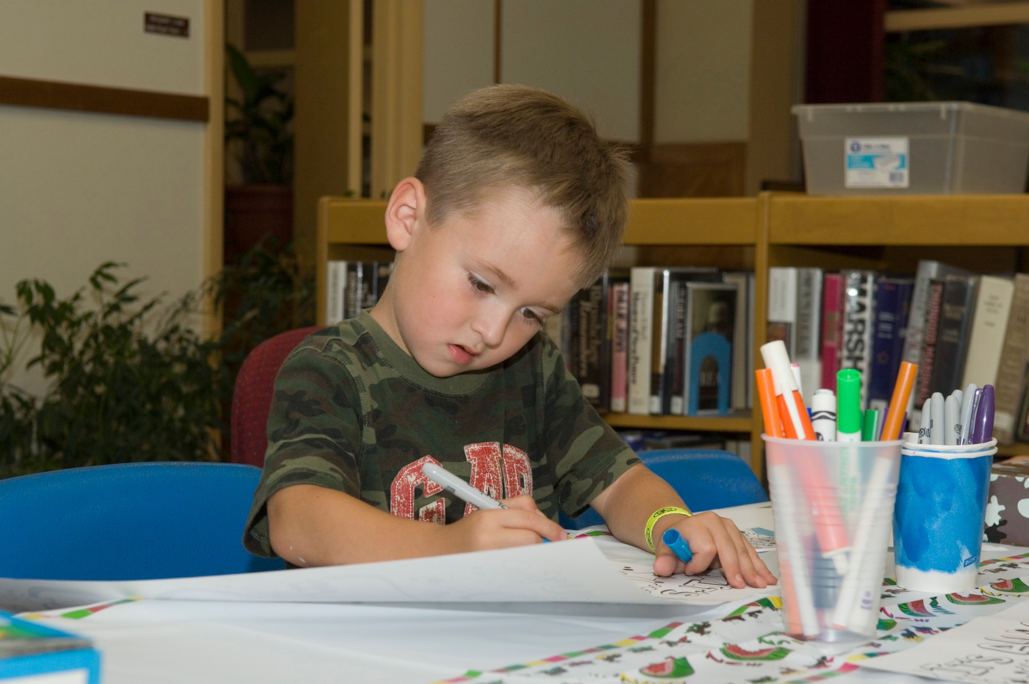 HANSCOM AFB, Mass. -- Aidan Blide, 5, enjoys coloring during the Airman and Family Readiness Center's Back to School Hearts Apart event in the Base Library, Aug. 27. Hearts Apart events are specifically designed for families of deployed and extended-temporary duty servicemembers. The gatherings allow families to connect during fun events and offer families a forum to discuss deployment-related concerns and issues. To learn more about the program, contact the A&FRC at (781) 377-4222. (U.S. Air Force photo by Rick Berry) 