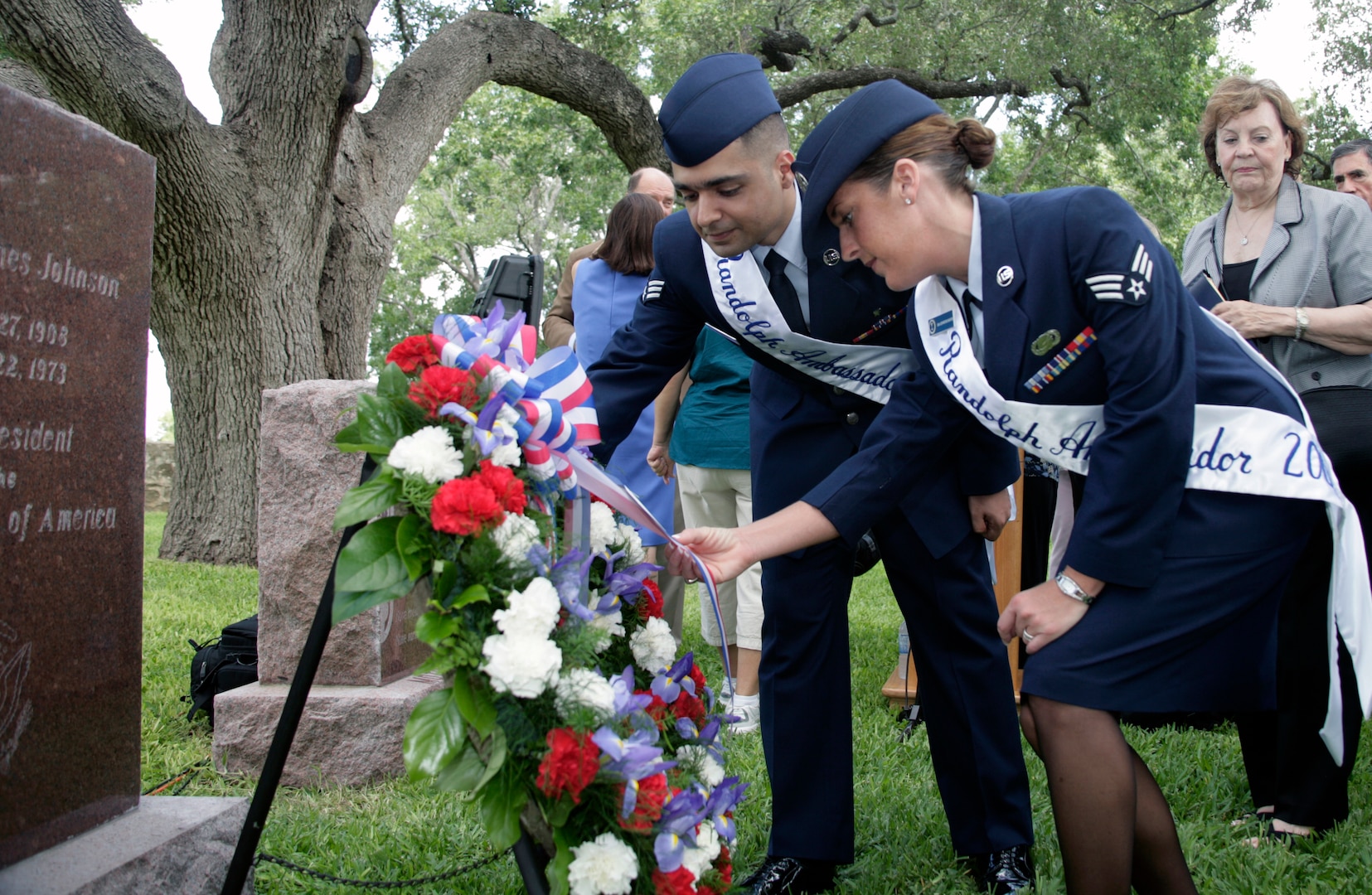 Senior Airmen Vikas Kumar and Jennifer Booth, both Randolph Air Force Base Ambassadors, straighten the wreath laid on the grave of President Lyndon B. Johnson Aug. 27. As the military commander closest to the ranch, the 12th FTW commander represents the sitting president each year by placing a wreath at President Johnson's grave on his birthday. (U.S. Air Force photo by Dan Solis)