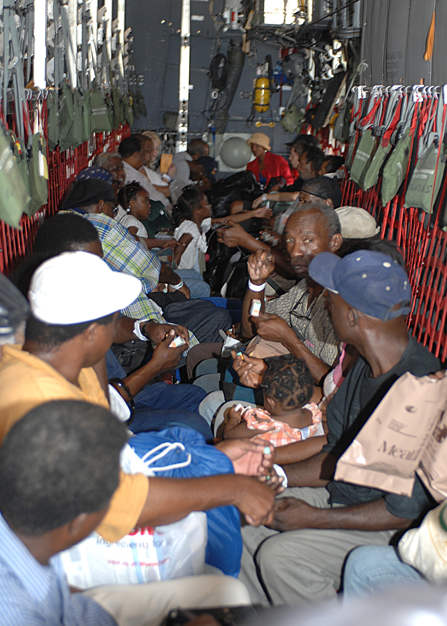 NEW ORLEANS INTERNATIONAL AIRPORT-- Hurricane Gustav evacuees await take off in a 317th Airlift Group C-130 from Dyess Air Force Base, Texas, August 31. Four C-130s and aircrews from Dyess AFB helped evacuate more than 6,500 New Orleans residents and more than 700 hospital patients. The evacuees were sent to different cities in Tennessee where relief teams were awaiting their arrival with food, water and shelter. (U.S. Air Force photo/ Senior Airman Jennifer Romig)