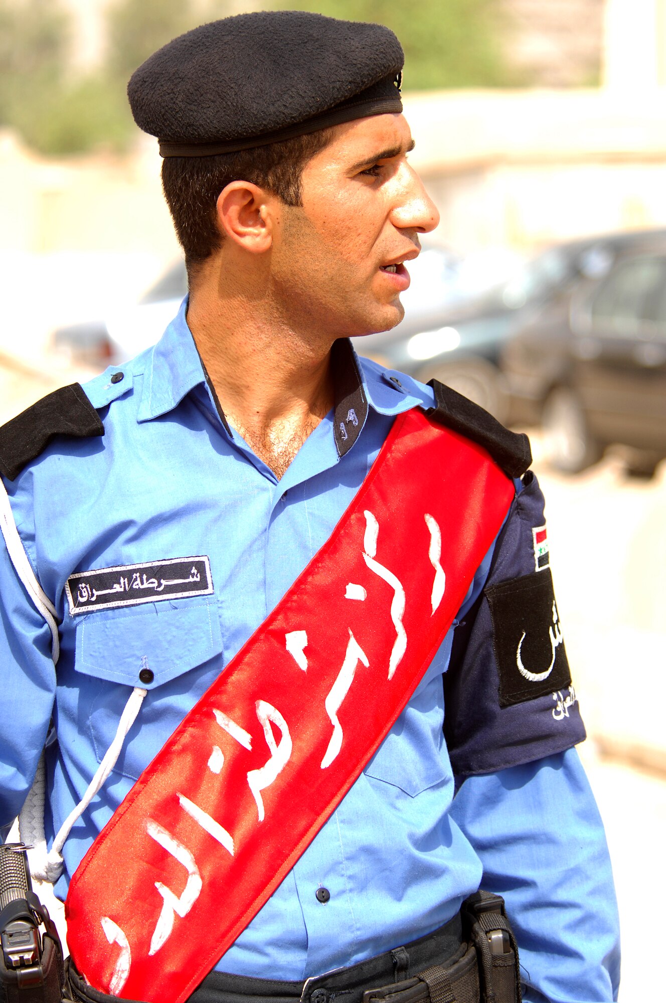 DOURA, IRAQ -- An Iraqi police officer gives instructions to other Iraqi policemen as they prepare to begin a combined patrol Aug. 30 with Airmen from the 732nd Expeditionary Security Forces Squadron, Det. 3 here. The combined patrol trained Iraqi police in tactics, techniques and procedures. The 732nd ESFS, Det. 3 is based at Victory Base in Baghdad with more than 150 Joint Source Solution Airmen performing Police Transition Team missions at six Iraqi police stations and one Iraqi police district headquarters in the East and West Rasheed Districts of Baghdad, in addition to manning two 24-hour Joint Security Stations. JSS Airmen are assigned duties outside their normal Air Force specialties to fill in vacant positions that Soldiers cannot support due to the Army's heavy theater operations tempo. (U.S. Navy photo/Petty Officer 2nd Class Kelvin T. Surgener)  