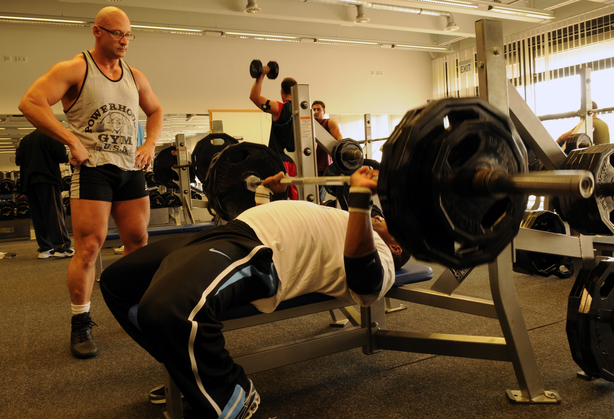 Master Sgt. Troy Saunders shares his knowledge with fellow power lifter, Staff Sgt. Lorenzo Peterson, at the Ramstein Southside Fitness Center. Both Sergeants, Sauders and Peterson, compete for the Ramstein power lifting and bodybuilding team that trains here on base. (U.S. Air Force photo by Airman 1st Class Scott Salsdukas)(Released)