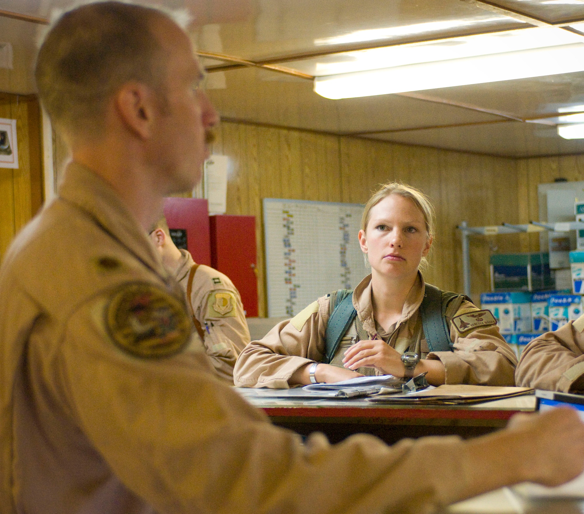 BAGRAM AIR FIELD, Afghanistan -- Capt. Vanessa Mahan, F-15E Strike Eagle weapons systems officer, receives her preflight briefing from Maj. Tom Laitinen here August 27, 2008. Before flight, pilots and WSOs must receive this briefing to make sure everyone is "on the same page" with the mission. Captain Mahan is deployed from the 335th Fighter Squadron, Seymour Johnson Air Force Base, N.C., and hails from St. John, Ind. (U.S. Air Force photo by Staff Sgt. Samuel Morse/Released)