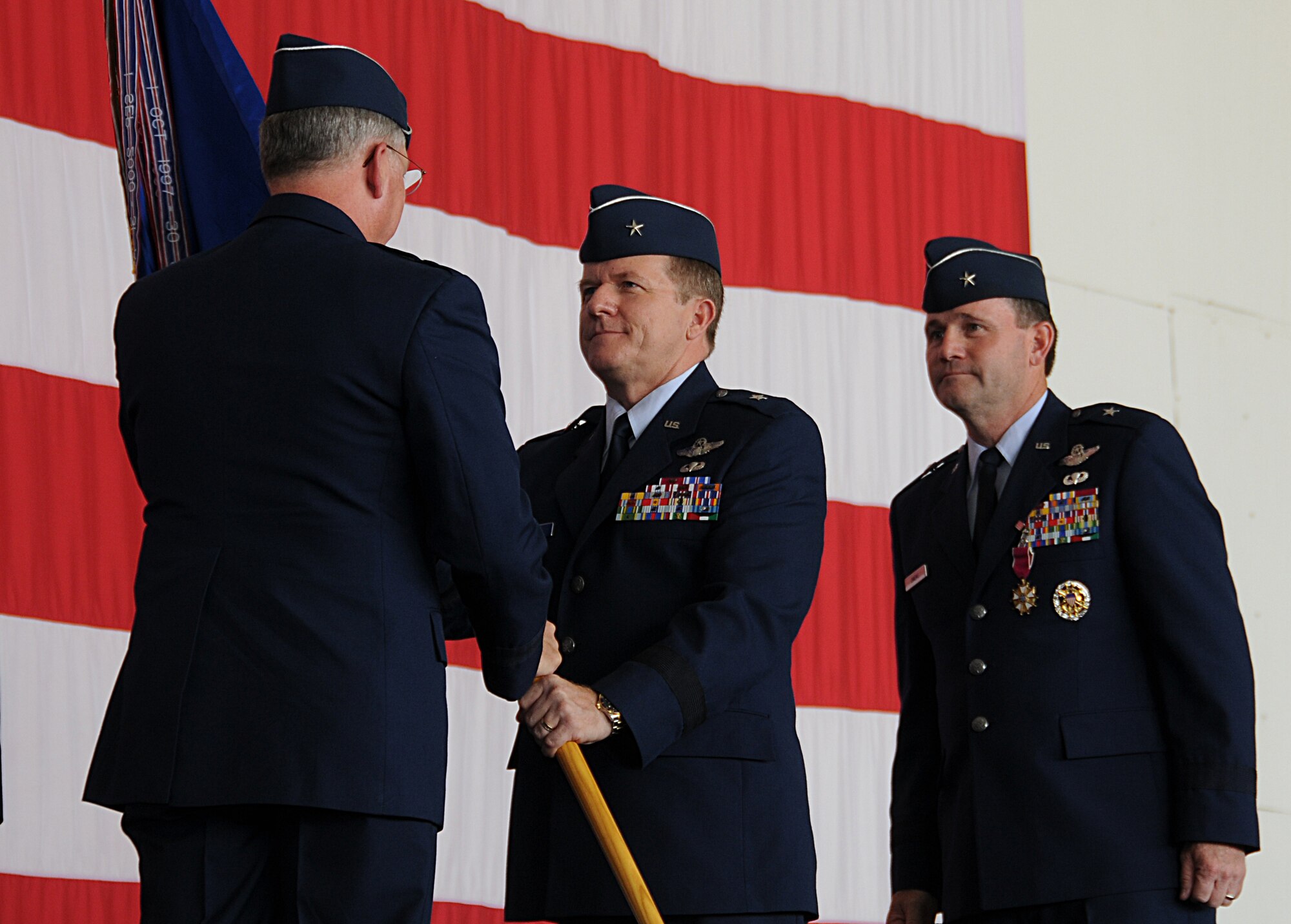 ANDERSEN AIR FORCE BASE, Guam - Lieutenant Gen. Chip Utterback, 13th Air Force commander, presents Brig. Gen. Philip Ruhlman with the 36th Wing guidon signifying the change of command Sept. 2 here. General Ruhlman arrives here from Joint Warfare, Supreme Allied Command Transformation, Stravenger, Norway where he was the Chief of Staff.  (U.S. Air Force by Staff Sergeant Jamie Lessard)