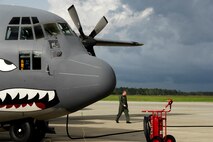 MOODY AIR FORCE BASE, Ga. -- Senior Airman Geoff Koppel, 71st rescue Squadron loadmaster, walks around a 71st RQS C-130E Hercules before a scheduled mission to deliver a Rescue Operations Center to Jackson, Miss. after Hurricane Gustaf made landfall Sept. 1.  The mission was not needed and the equipment has been placed back on ready-alert status for the next storm response.  (U.S. Air Force photo by Tech. Sgt. Parker Gyokeres)