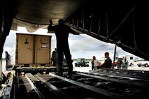 MOODY AIR FORCE BASE, Ga. -- A loadmaster with the 71st rescue Squadron Guides a Rescue Operations Center kit onto a 71st RQS C-130E Hercules here Sept. 1. The ROC was scheduled to be deployed to Jackson, Miss. to provide command and control for rescue teams. It was not needed and has been placed back on a ready-alert status until the next storm response.  (U.S. Air Force photo by Tech. Sgt. Parker Gyokeres)
