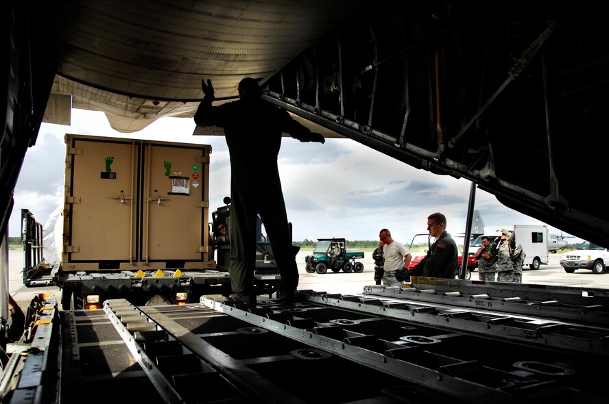 MOODY AIR FORCE BASE, Ga. -- A loadmaster with the 71st rescue Squadron Guides a Rescue Operations Center kit onto a 71st RQS C-130E Hercules here Sept. 1. The ROC was scheduled to be deployed to Jackson, Miss. to provide command and control for rescue teams. It was not needed and has been placed back on a ready-alert status until the next storm response.  (U.S. Air Force photo by Tech. Sgt. Parker Gyokeres)
