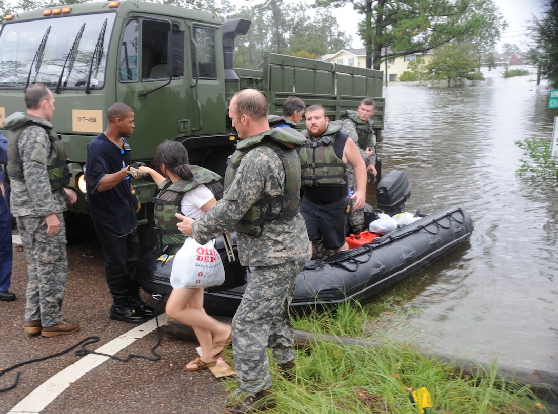 Members of the Mississippi Army National Guard's 20th Special Forces Group launch rubber boats fitted with outboard motors to rescue residents of the flooded Jordan River Shores subdivision in Kiln, Miss., Sept. 1, 2008.