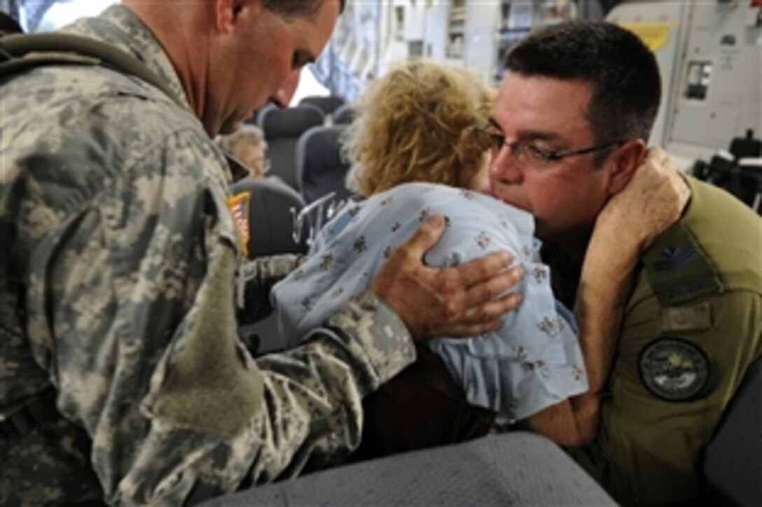 U.S. and Canadian Armed Forces personnel help an evacuee of Hurricane Gustav to board an emergency departure flight. The U.S. Federal Emergency Management Agency and the Department of Defense chartered planes to transport citizens to destinations safely outside the hurricane's path, Lake Front Airport, New Orleans, Aug. 31, 2008.