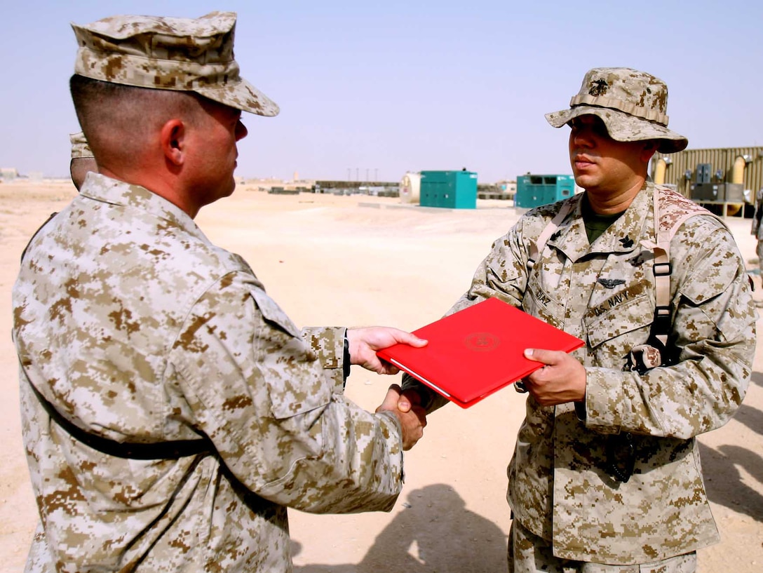 Marine Air Control Squadron 1 commanding officer, Lt. Col. Marine Air Control Squadron 1 commanding officer, Lt. Col. Jeff Kojac, hands a certificate to Petty Officer 1st Class Jose Diaz, an air traffic controller with MACS-1, for earning a Fleet Marine Force Warfare Specialist badge Sept. 2 during a ceremony at the base air traffic control tower here. Six controllers earned their FMF badge during their deployment with MACS-1, 3rd MAW (Fwd.). “I am very proud of the hard work and time the sailors put in to earning something that isn’t required for their job,” said Kojac. (U.S. Marine Corps photo by Lance Cpl. Fredrick J. Coleman) (Released)