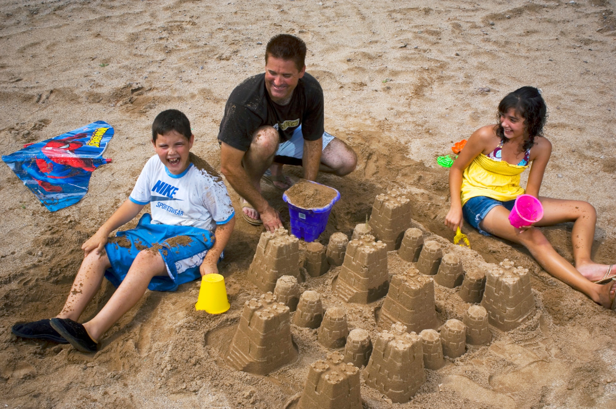 Horror at Harkers Island - Playing in the sand with his son, J.J., and daughter, Josie, Staff Sgt. Jay Rosenberry of the Tucson Air National Guard cherishes these moments after his children nearly drowned in the Atlantic Ocean. Rosenberry risked his own life to save his children and another boy, and on April 11, the Coast Guard awarded him with its Silver Lifesaving Medal for his heroic actions. (photo by Tech. Sgt. Matthew Hannen)