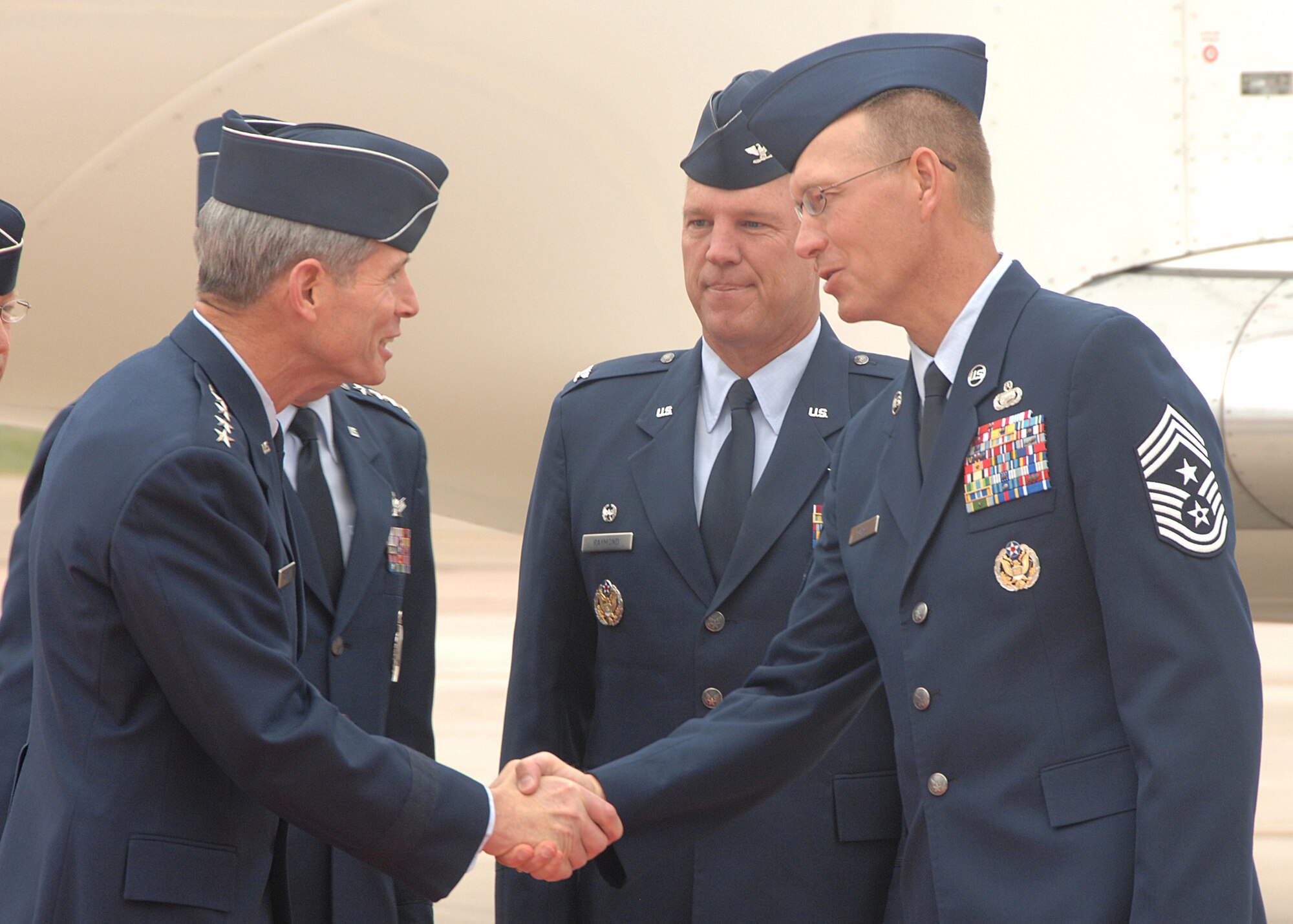 Air Force Space Command Chief Richard Small (right), and Col. Jay Raymond, 21st Space Wing commander, greet Gen. Norton Schwartz, Air Force Chief of Staff upon his arrival at Peterson Air Force Base, Colo., Sept. 2. (U.S. Air Force photo/Tech. Sgt. Matthew Lohr)