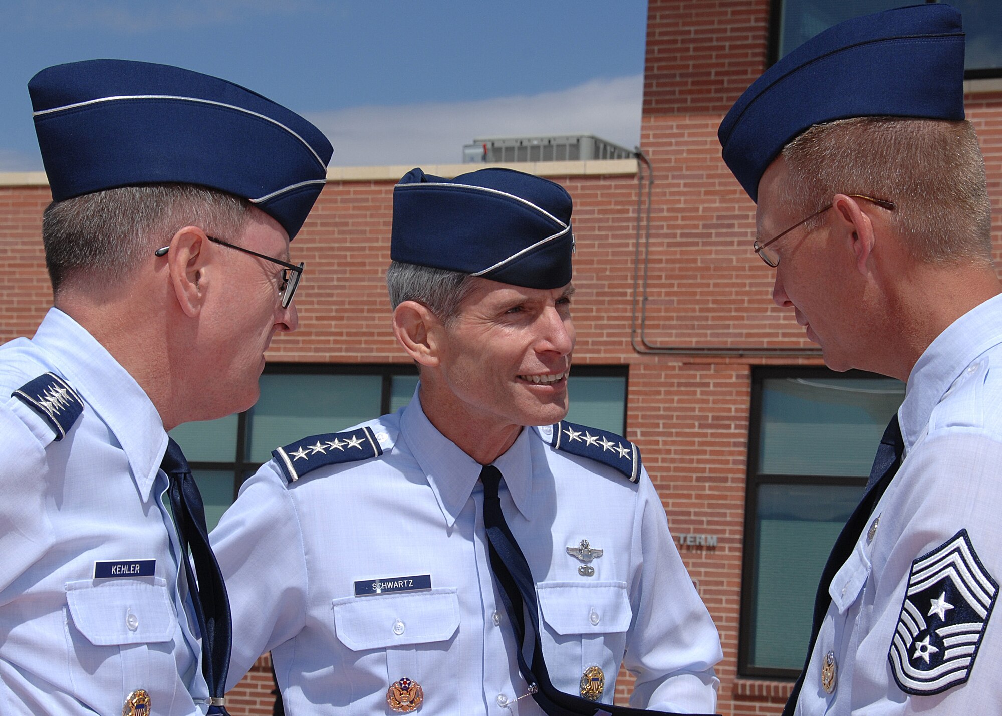 Air Force Space Command Commander Gen. C. Robert Kehler (left) and AFSPC Command Chief Todd Small (right) say farewell to Gen. Norton A. Schwartz, Air Force Chief of Staff, after he addressed Airmen at Peterson Air Force Base, Colo., Sept. 2. (U.S. Air Force photo/Duncan Wood)