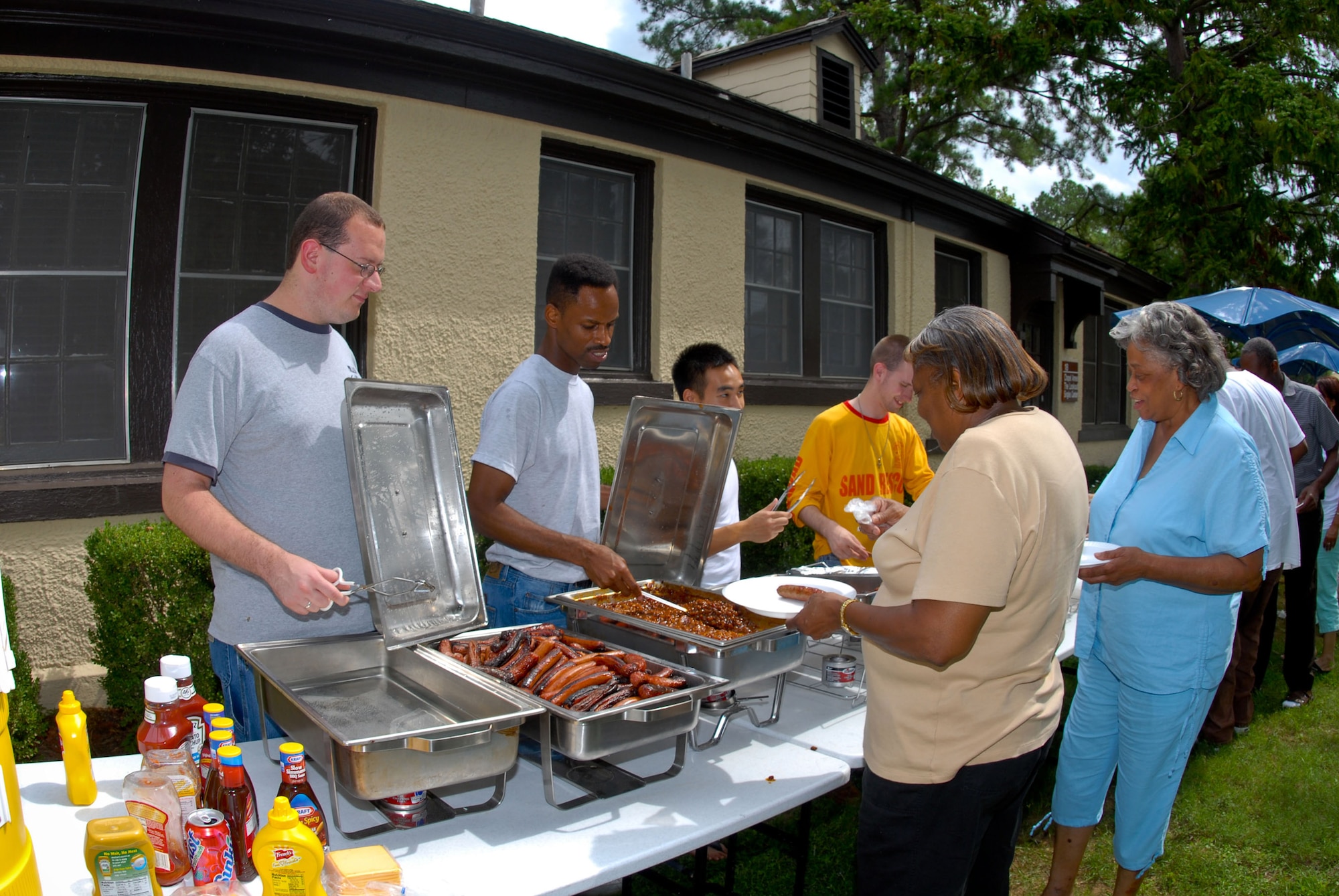 Staff members from the 42nd Air Base Wing base chapel serve lunch Sept. 1 to Hurricane Gustav evacuees staying on Maxwell Air Force Base, Ala.  The chapel staff served food to about 150 of the more than 650 military and family members and government employees who evacuated to Maxwell from the Gulf Coast.   (U.S. Air Force photo/Jamie Pilcher)