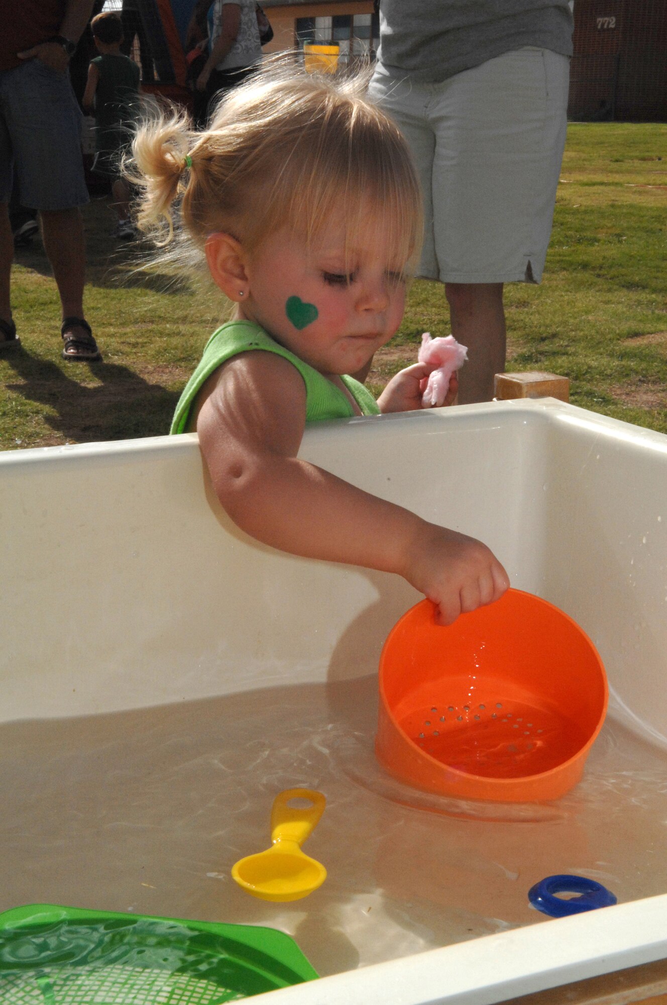 Annabella, 1, daughter of Airman 1st Class Bernard Josephs, 49th Materiel Maintenance Support Squadron, and wife, Crystal, plays with the toys in a water bin at the Back to School Carnival at Holloman Air Force Base, N.M., August 29. . More than 350 people attended the carnival that kicked off the new school year with some fun. (U.S. Air Force photo/Airman Sondra M. Escutia)