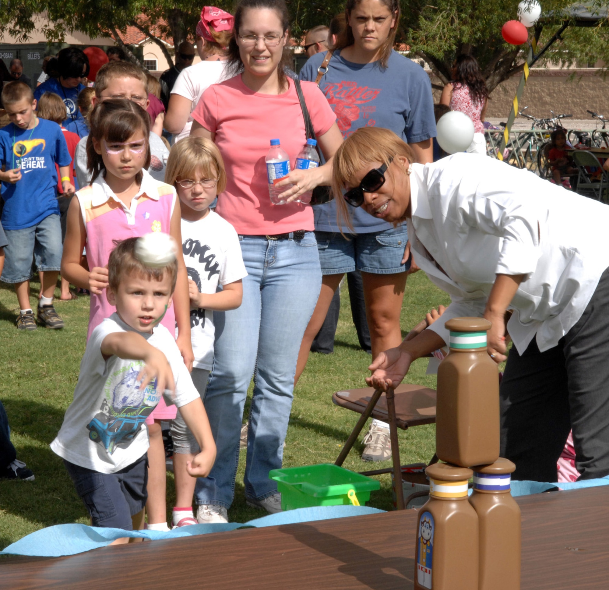 Ian, 4, son of Staff Sgt. Rebecca Osborne, 49th Maintenance Operations Squadron, throws a ball at the jars to win a prize at the Back to School Carnival at Holloman Air Force Base, N.M., August 29. According to Ms. Azure Bibeault, the event coordinator, the carnival was held to welcome children back to school, both returning and new students, and kick off the new school year with some fun. (U.S. Air Force photo/Airman Sondra M. Escutia)