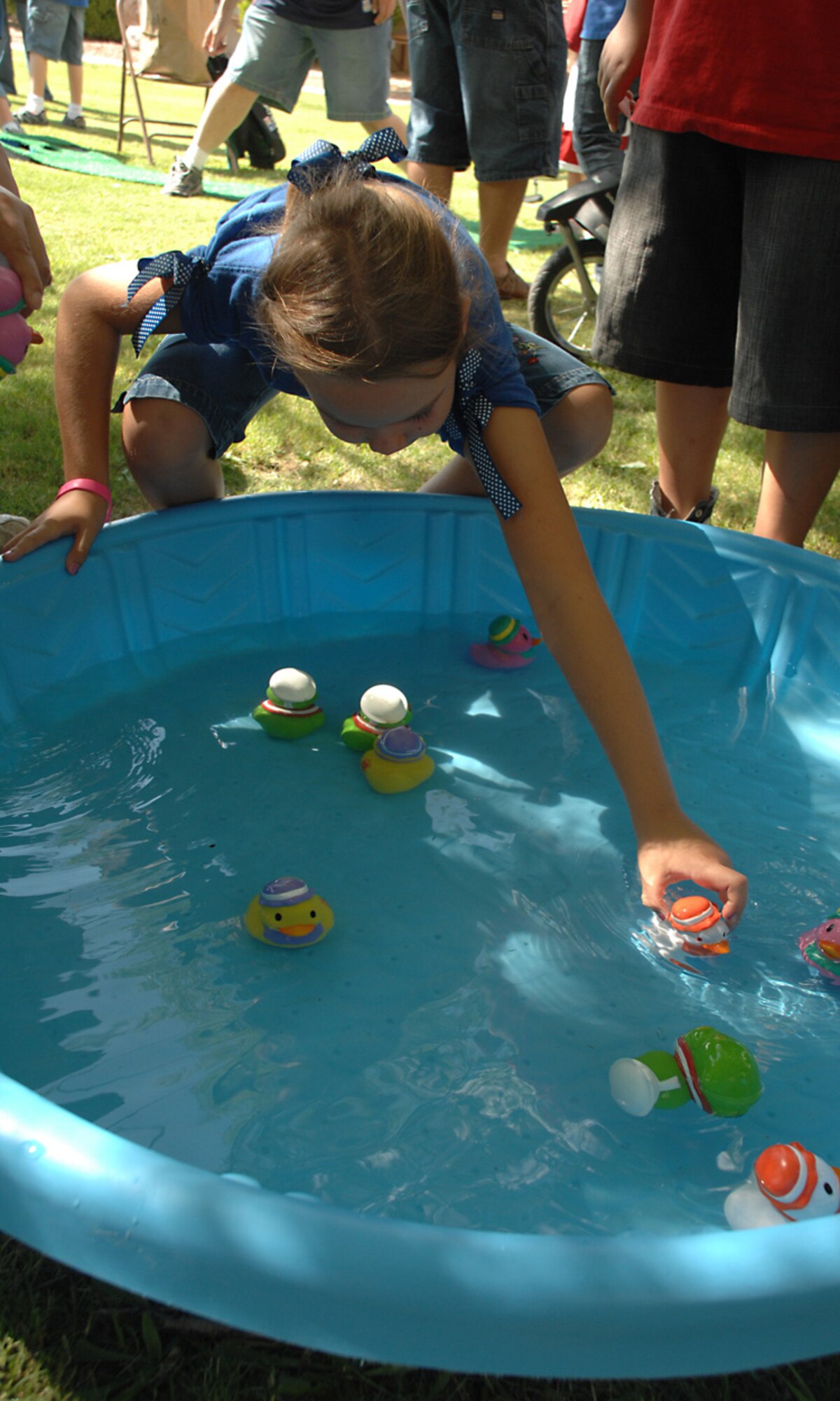 McKenzie Campbell, 6, reaches for a duck during the Back to School Kid's Carnival at Holloman Air Force Base, N.M., Aug. 30. McKenzie is the daughter of Maj. Jason Campbell, 49th Logistics Readiness Squadron operations officer. (U.S. Air Force photo/ Senior Airman Tiffany Trojca)