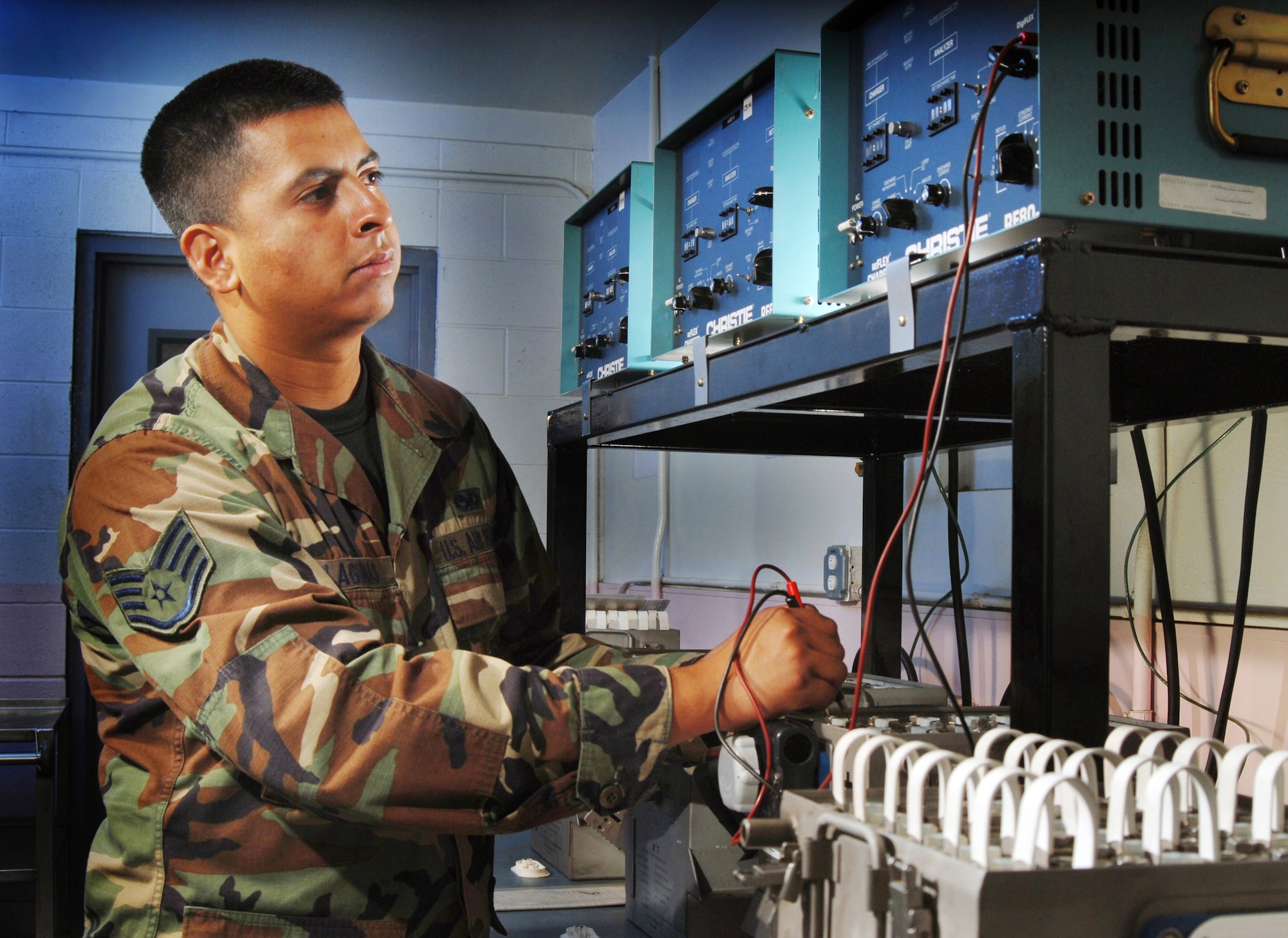 Staff Sgt. Abraham Lagunas, an aircraft mechanic, uses a multi-meter to check the lead cell voltage on a C-17 Globemaster III nickel-cadmium battery while it's being recharged at March Air Reserve Base, Calif. on Sept. 3. Sergeant Lagunas is an air reserve technician from the 452nd Maintenance Squadron. (U.S. Air Force photo/Val Gempis)