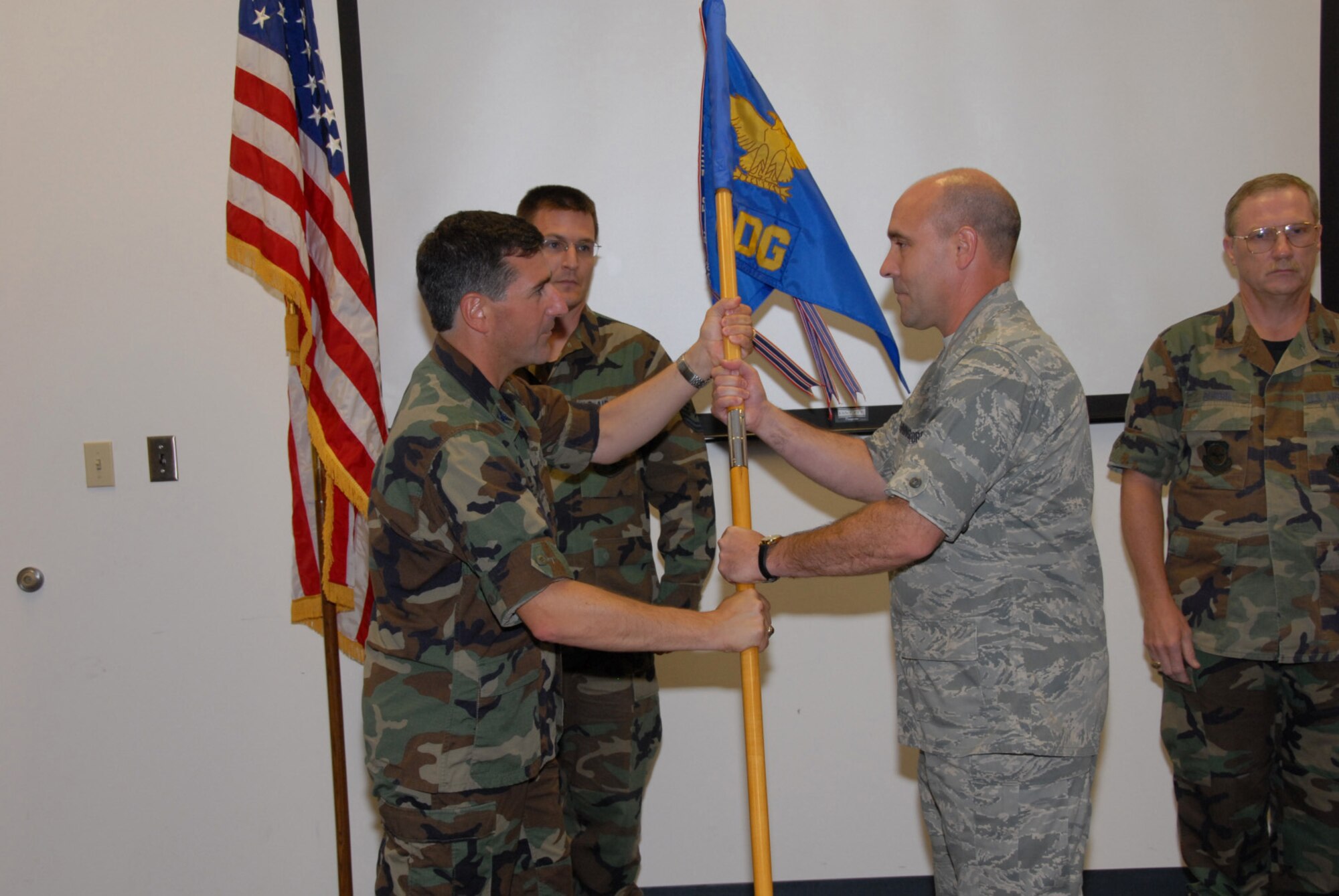 SCOTT AIR FORCE BASE, Ill. - Lt. Col. Jon Boehning accepts the guideon and command of the 126th Medical Group from Col Peter Nezamis, commander of the 126th Air Refueling Wing, as Master Sgt. Mark Teigland, the 126 MDG first sergeant looks on.  (U.S. Air Force photo by Tech. Sgt. Mike Rice)