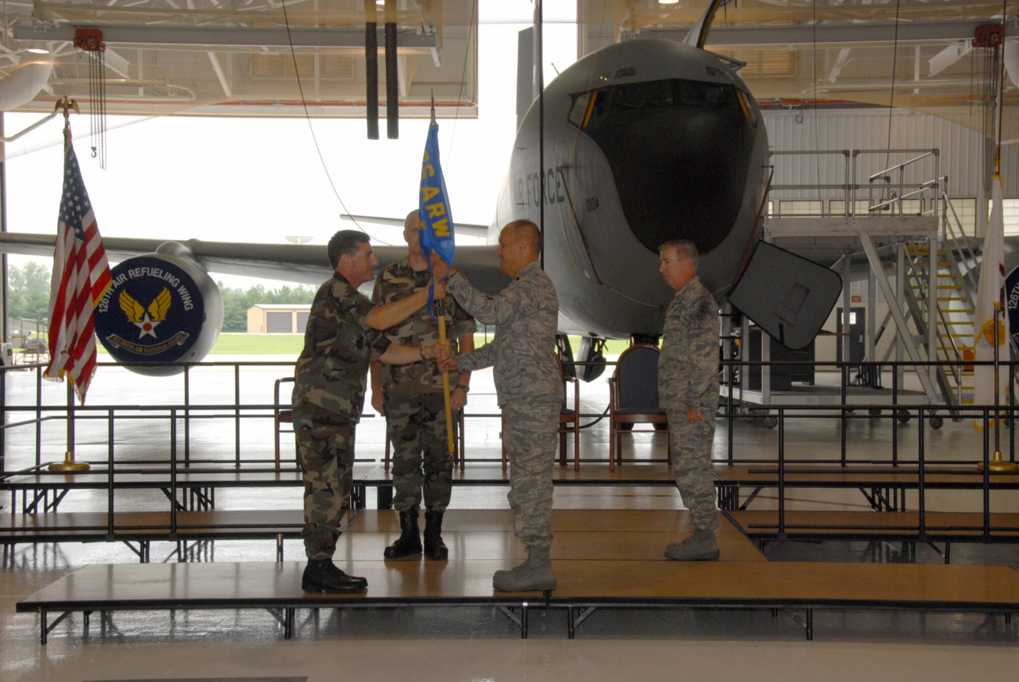 SCOTT AIR FORCE BASE, Ill. - Lt. Col. Rick Keasey accepts the guideon and command of the 126th Maintenance Group from Col. Peter Nezamis, commander of the 126th Air Refueling Wing, as Chief Master Sgt. Mark Berens, the 126 MXG quality assurance chief ,looks on.  (U.S. Air Force photo by Master Sgt. Franklin Hayes)