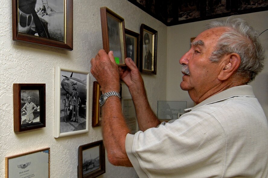MINOT AIR FORCE BASE, N.D. – Elmer Wolf, a World War II veteran and true living legend, shows a display of photos and memorabilia from his time in the Army Air Corps. The Living Legends group began with the donation of Mr. Wolf’s service-dress uniform. (U.S. Air Force photo by Senior Airman Kelly Timney)
