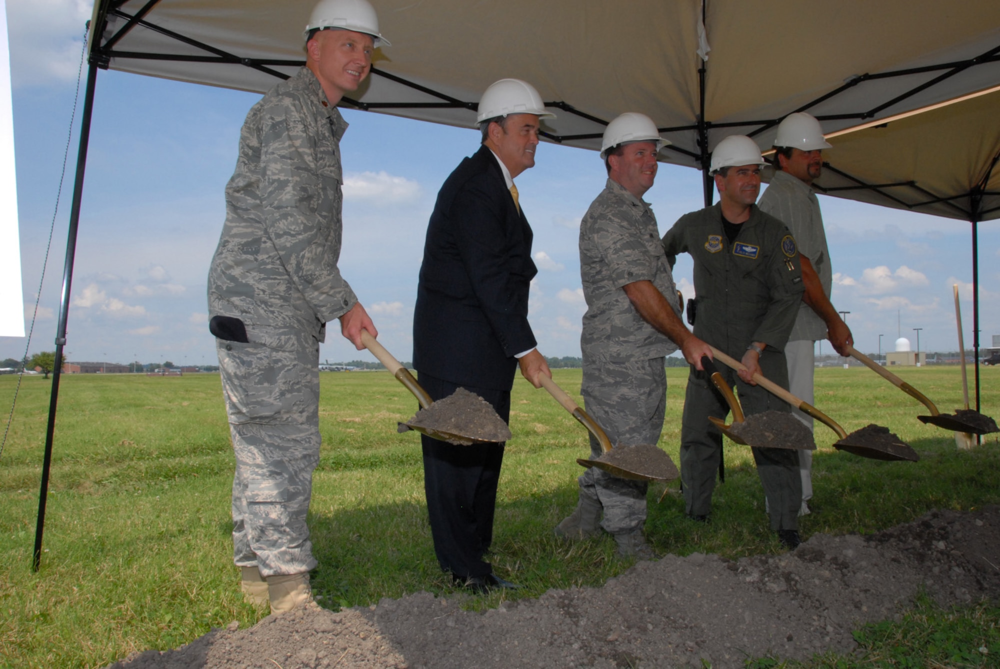 SCOTT AIR FORCE BASE, Ill. - (L - R) Maj. Robert Rossi, commander of the 375th Security Forces Squadron, the Honorable Jerry F. Costello, U.S. Congressman for Illinois 12th District, Col. Alan Hunt, 375th Airlift Wing commander, Col. Peter Nezamis, commander of the 126th Air Refueling Wing, and a representative from Scott Alliance Joint Venture, Inc. break ground for the new Security Forces Operations Facility.  The state of the art building will provide work and training areas for active duty personnel from the 375th Airlift Wing and Illinois Air National Guardsmen from the 126th Air Refueling Wing. (U.S. Air Force photo by Master Sgt. Ken Stephens)
