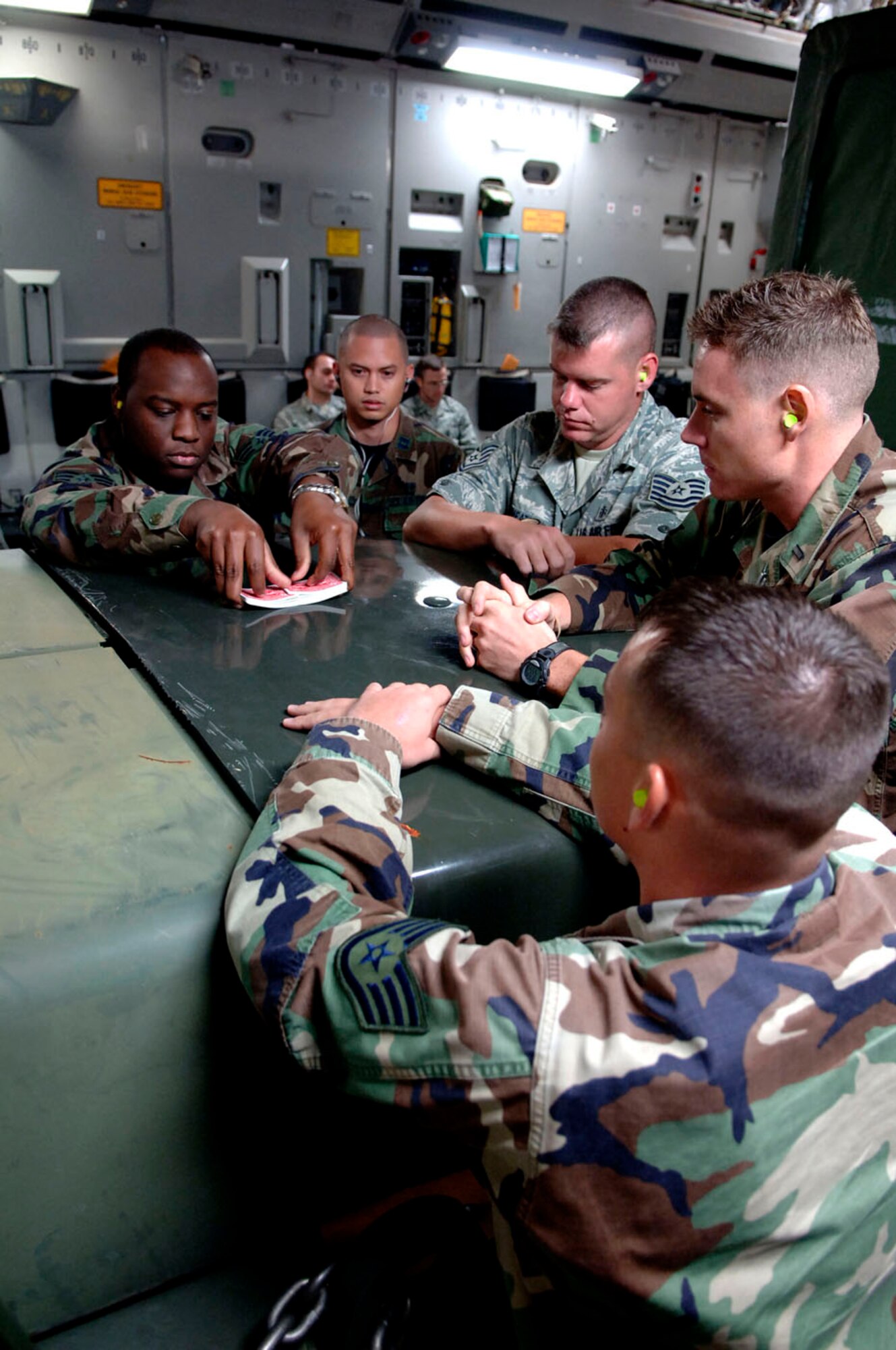 Members of 6th Medical Group from MacDill Air Force Base pass the time on a C-17 Globemaster by playing cards. The team deployed to Beaumont, Texas, in preparation for hurricane Gustav's arrival. (U.S. Air Force photo by Staff Sgt. Joseph Swafford)