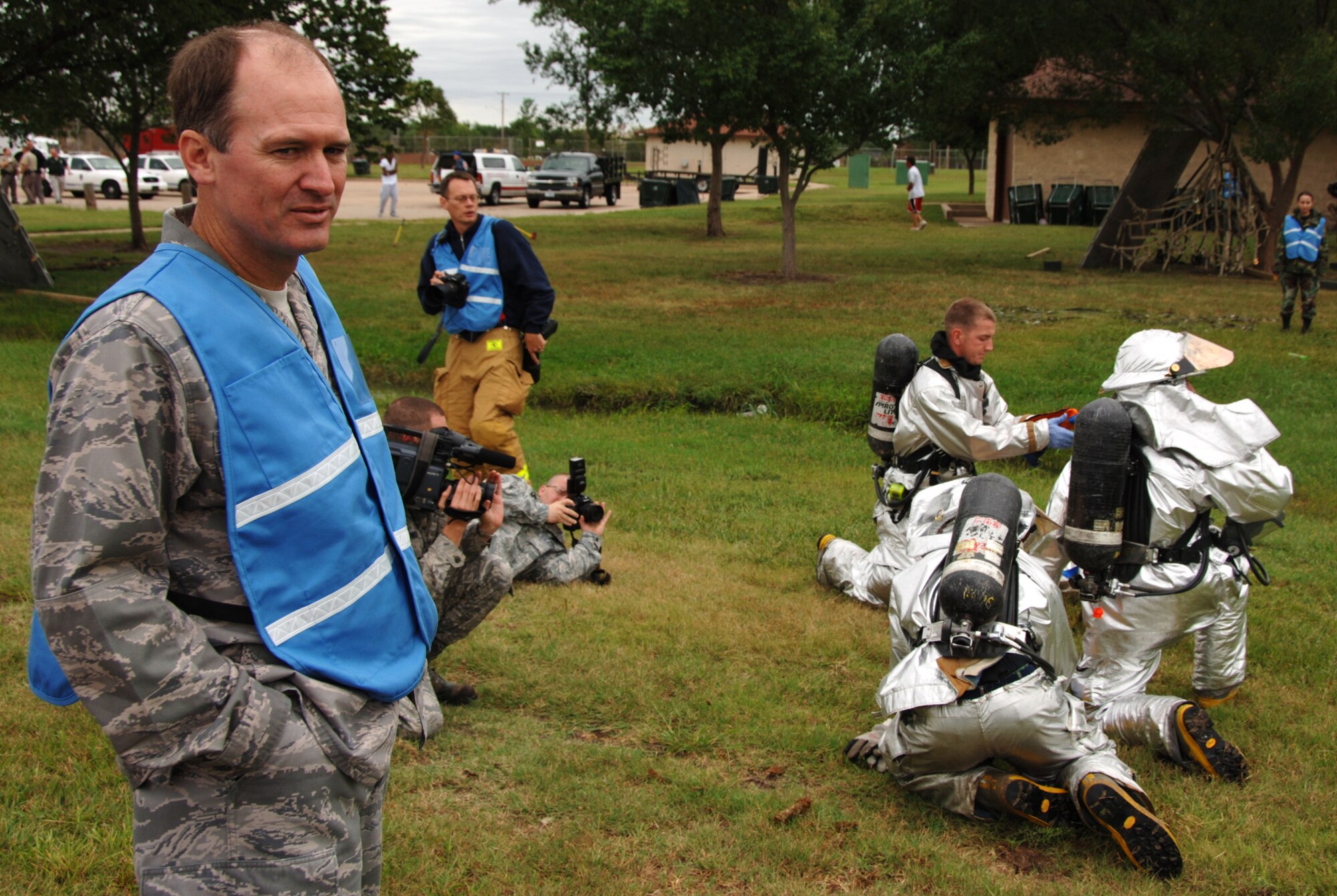 Lt. Col. Clint Burpo (far left) watches Air Force and local emergency response personnel evacuate simulated crash victims during a major accident response exercise just outside McConnell Air Force Base, Kan., on Sept. 3. The exercise was coordinated by the 22nd Air Refueling Wing, the 931st's host wing at McConnell. Colonel Burpo, an air reserve technician assigned to the 931st Air Refueling Group's Plans and Programs office, helped the 22nd ensure safety during the exercise was not unnecessarily compromised on a cold and rainy day.