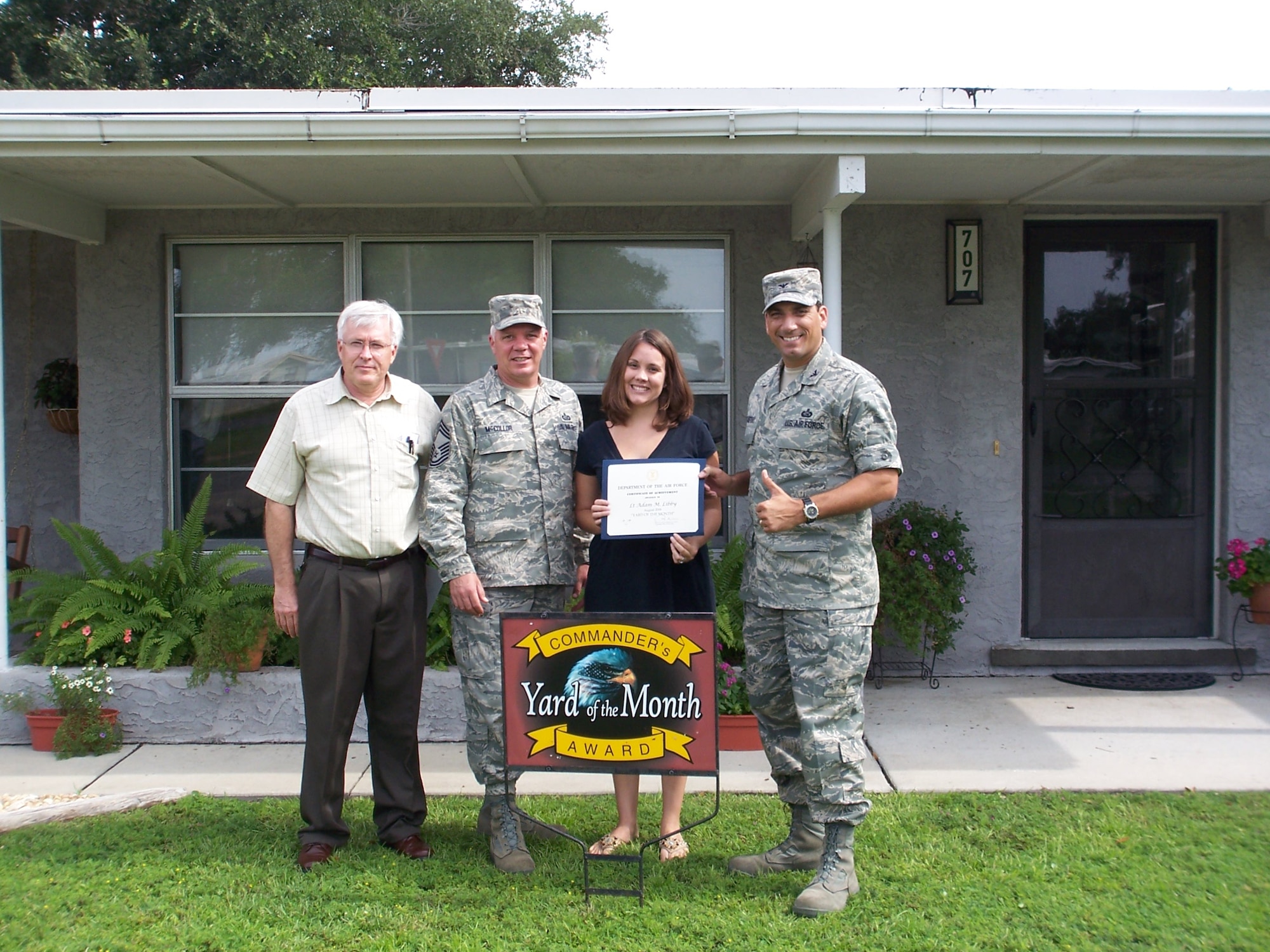 (Far right) Col. Rick LoCastro, 96th Air Base Wing vice commander, and other Team Eglin leadership recognized Elizabeth Libby, wife of 2nd Lt. Adam Libby for the August Yard of the Month event. (Courtesy photo)