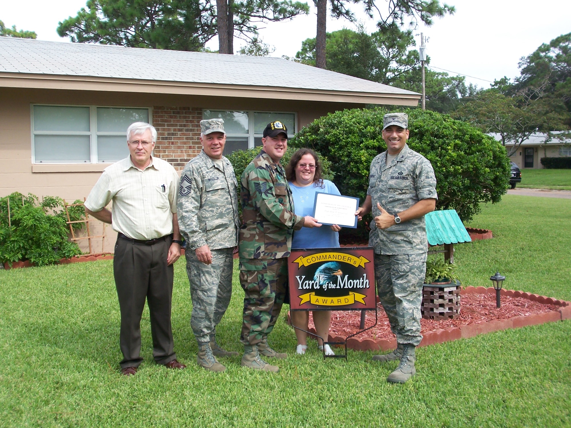 (Far right) Col. Rick LoCastro, 96th Air Base Wing vice commander, recognized Sherry Goodrow, wife of Master Sgt. Christopher Goodrow assigned to the 6th Army Ranger Battalion, recently for the Yard of the Month function. 