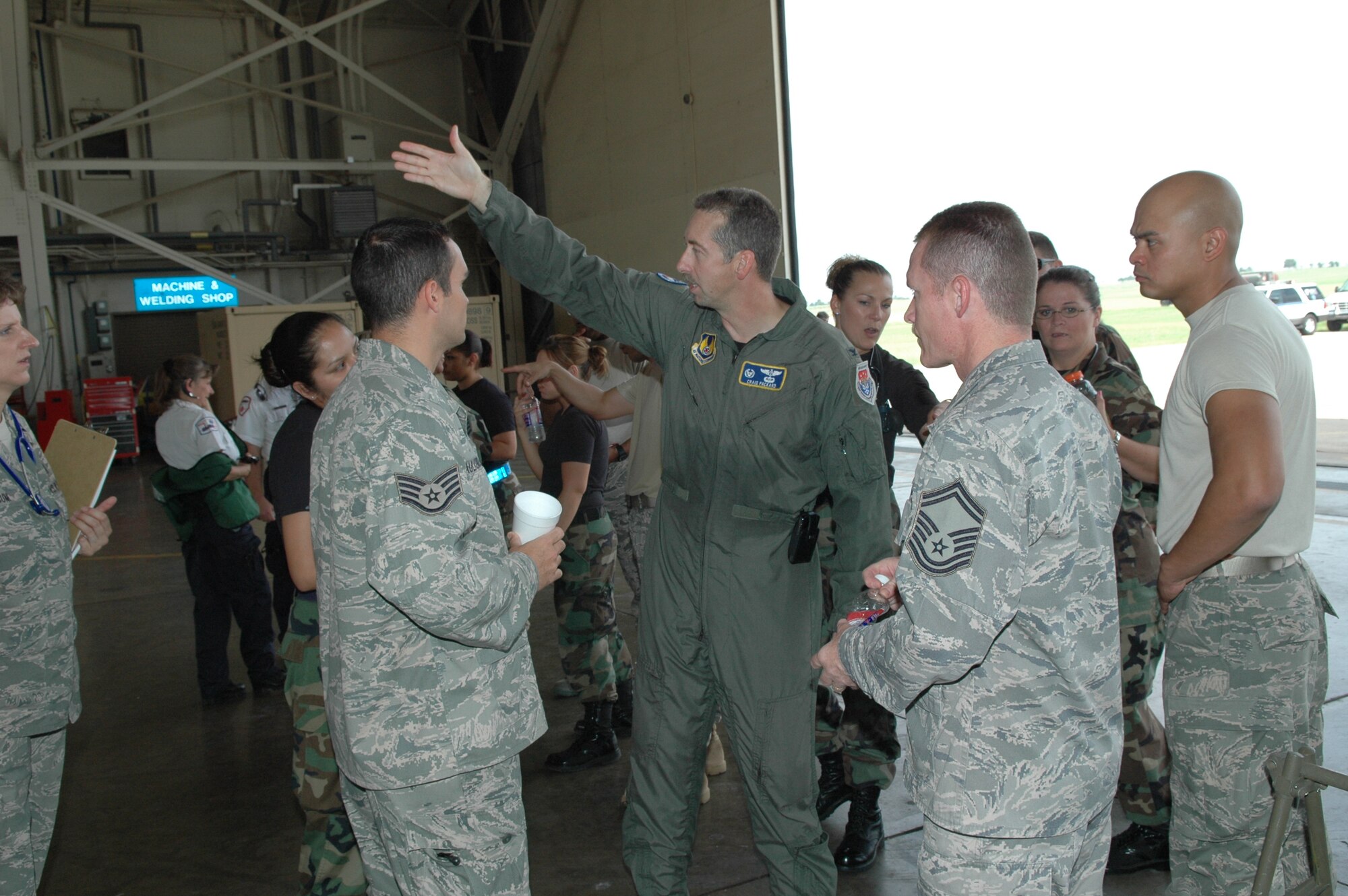 Col. Craig Packard, 72nd Aerospace Med Squadron commander, addresses members of the 72nd Medical Group as they prepare for an influx of critically ill patients at Will Rogers World Airport. The medical group, along with the Guard members and other federal agencies were on hand Sunday to assist in the transition of patients as part of the National Disaster Medical System, federal program that aids regional medical staff in peacetime disasters. (Air Force photo/Ralph Monson)