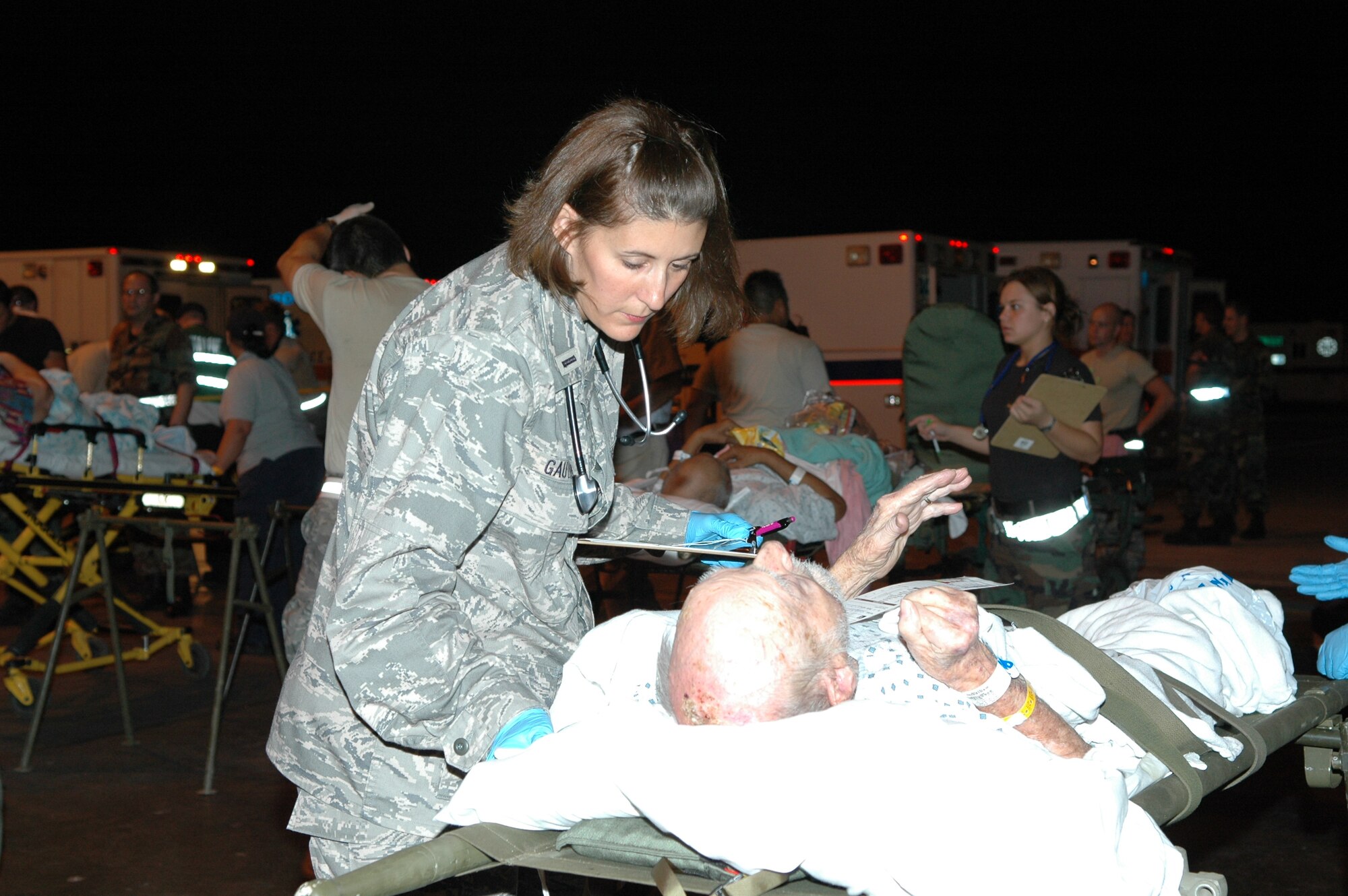 1st Lt. Valerie Gauthier, 72nd Medical Operations Squadron nurse, looks after a patient evacuated ahead of Hurricane Gustav Sunday. Fears of a Katrina repeat had officials out in front of Gustav. Critically ill patients were evacuated from the affected region as part of the National Disaster Medical System. Airmen from Tinker and the Air National Guard at Will Rogers World Airport were there to help process the patients and get them to waiting.(Air Force photo/Ralph Monson)