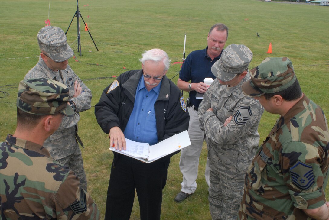 Keith Victor (center), Chairman, and Chris Marvin (center right), Co-Chair, for Region 3 of the Capital Region Emergency Planning Committee, coordinate with members of the Connecticut National Guard’s Joint Incident Site Communication Capability (JISCC) team at Camp Rell, Niantic, Connecticut on June 5, 2008.  The planning session is part of the effort to link the JISCC system to the capital region’s four mobile command posts.  Linking the systems allows local and state emergency services to coordinate with Army and Air National Guard resources to aid in disaster relief efforts. (U.S. Air Force photo by Staff Sgt. Nicholas A. McCorkle)
