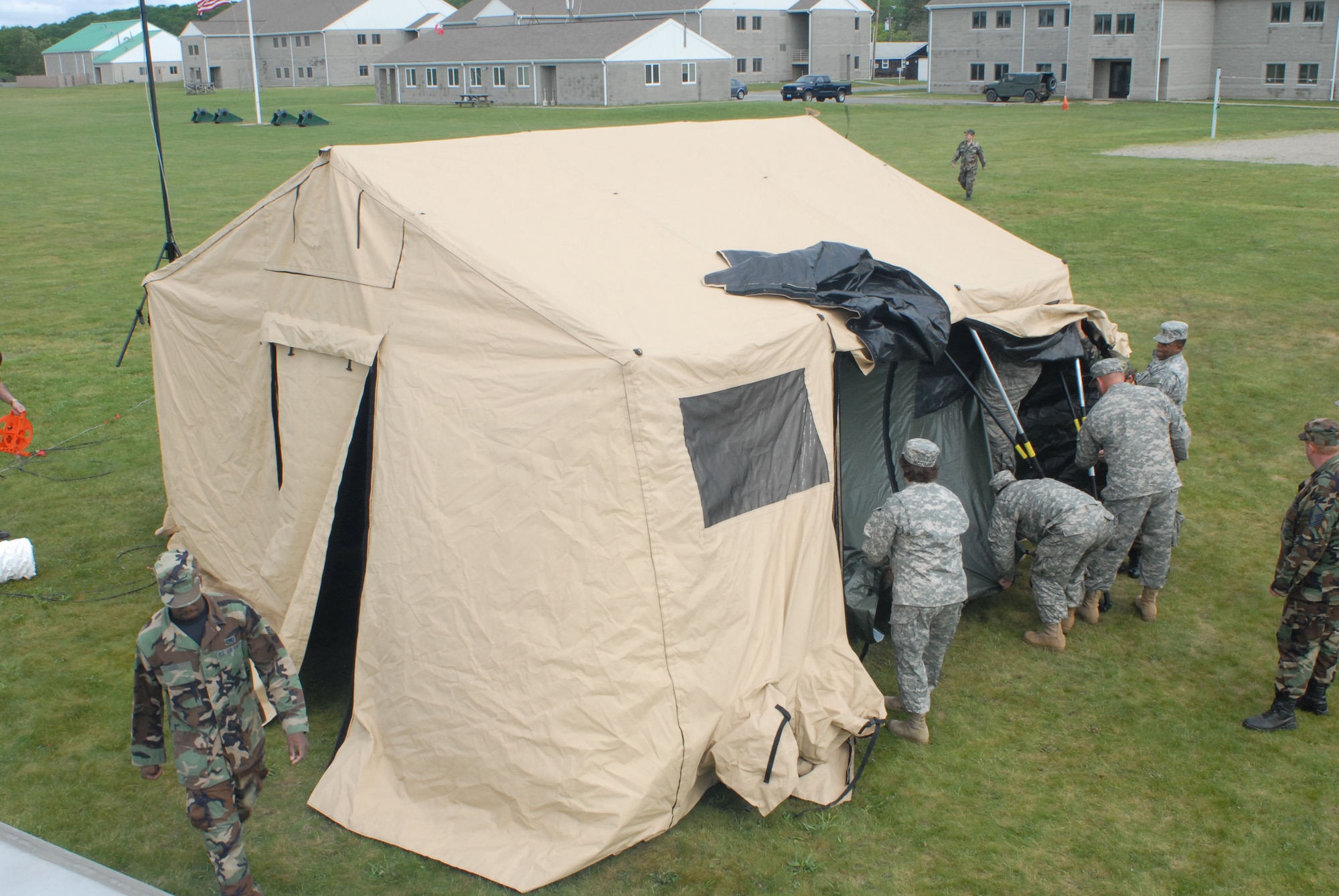 A joint team of Army and Air National Guard personnel set up the Joint Incident Site Communication Capability (JISCC) tent during the June 5, 2008 deployed training exercise at Camp Rell, Niantic, Connecticut. The JISCC is able to arrive at an incident site, and rapidly provide global communications to on-scene commanders, including satellite communications, video teleconferencing, secure voice transmissions, and internet capabilities. (U.S. Air Force photo by Staff Sgt. Nicholas A. McCorkle) 
