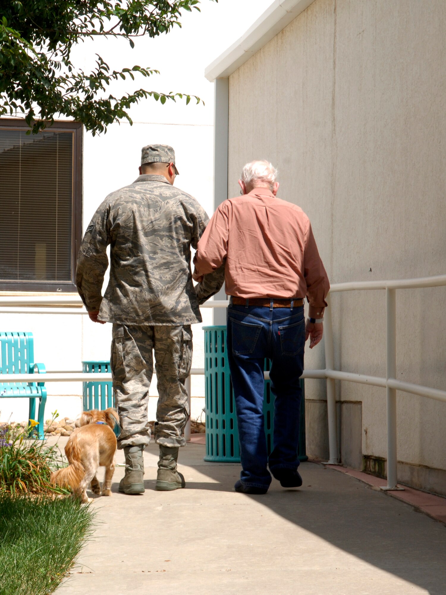 CANNON AIR FORCE BASE, N.M. -- Airman 1st Class Timothy Lopez, 27th Special Operations Component Maintenance Squadron, takes a walk with retired Soldier William Conrad, during a visit to Thomas E. Creek Veteran Medical Center in Amarillo, Texas, Aug. 28. The visit was organized by the Middle Tier, who visits the hospital quarterly. (U.S. Air Force photo/Airman 1st Class Evelyn Chavez) 