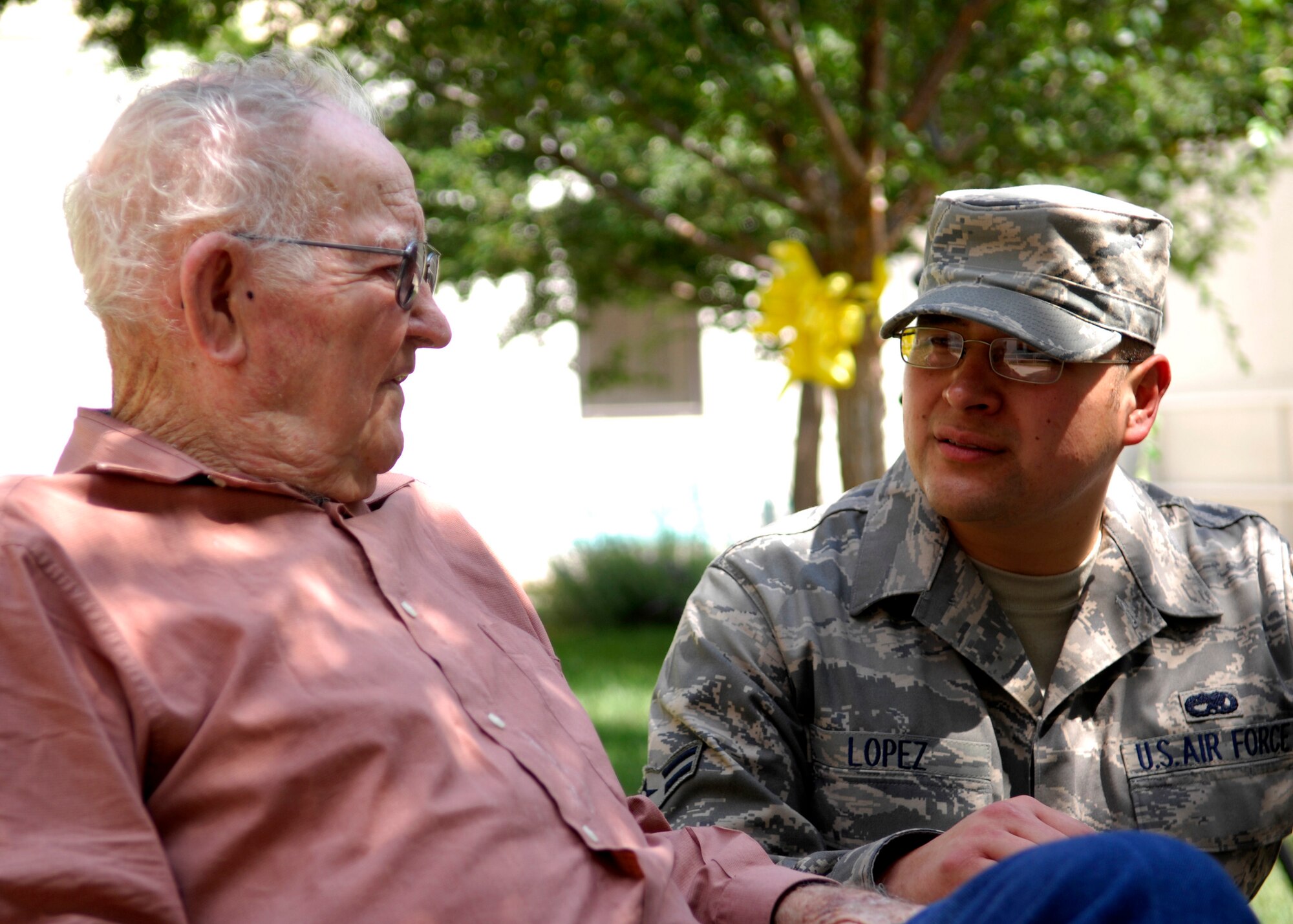 CANNON AIR FORCE BASE, N.M. -- Airman 1st Class Timothy Lopez, 27th Special Operations Component Maintenance Squadron, converses with retired Soldier William Conrad during a visit to Thomas E. Creek Veteran Medical Center in Amarillo, Texas, Aug. 28. The visit was organized by the Middle Tier, who visits the hospital quarterly. (U.S. Air Force photo/Airman 1st Class Evelyn Chavez) 